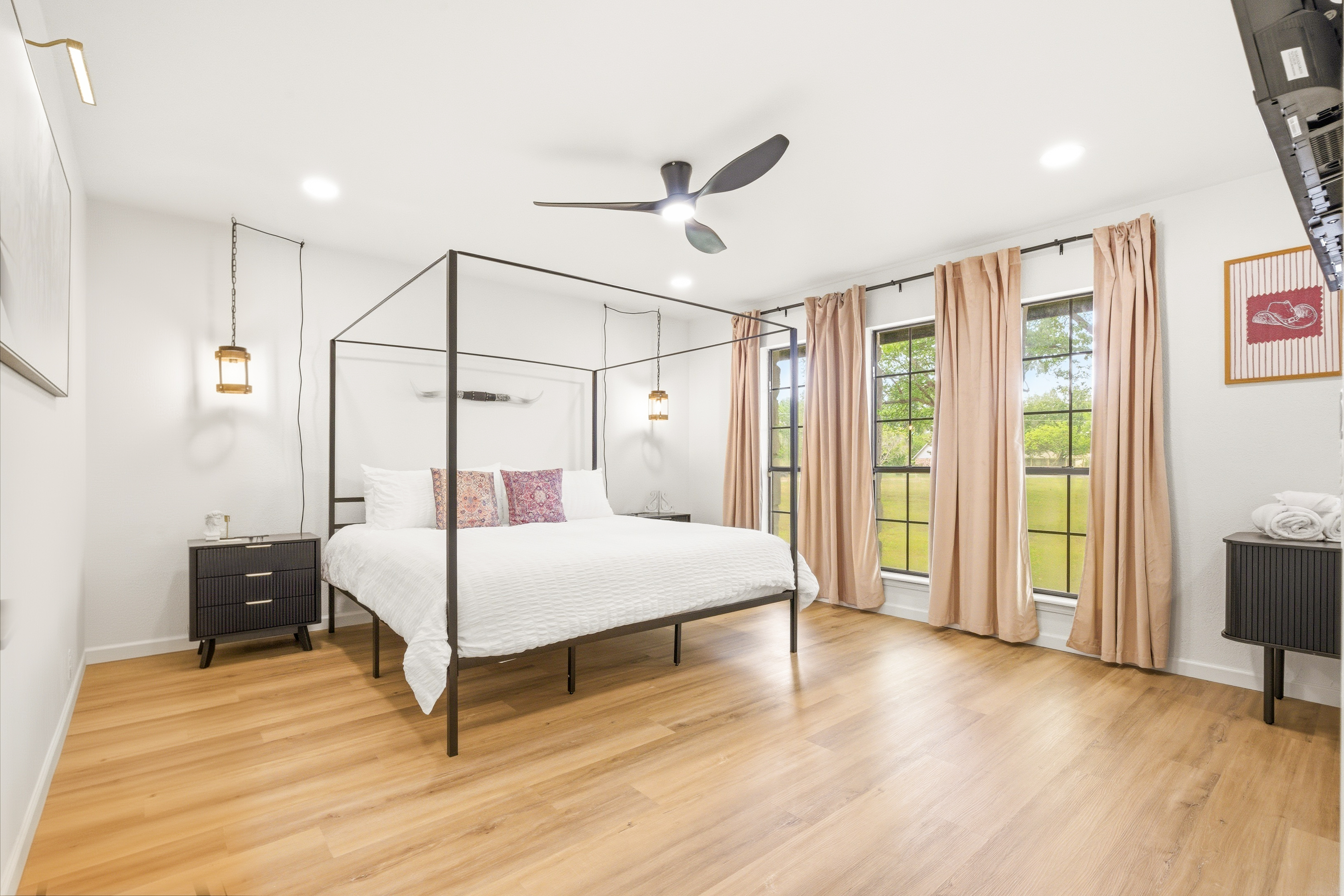 Bright, airy bedroom with four-poster bed and serene outdoor views