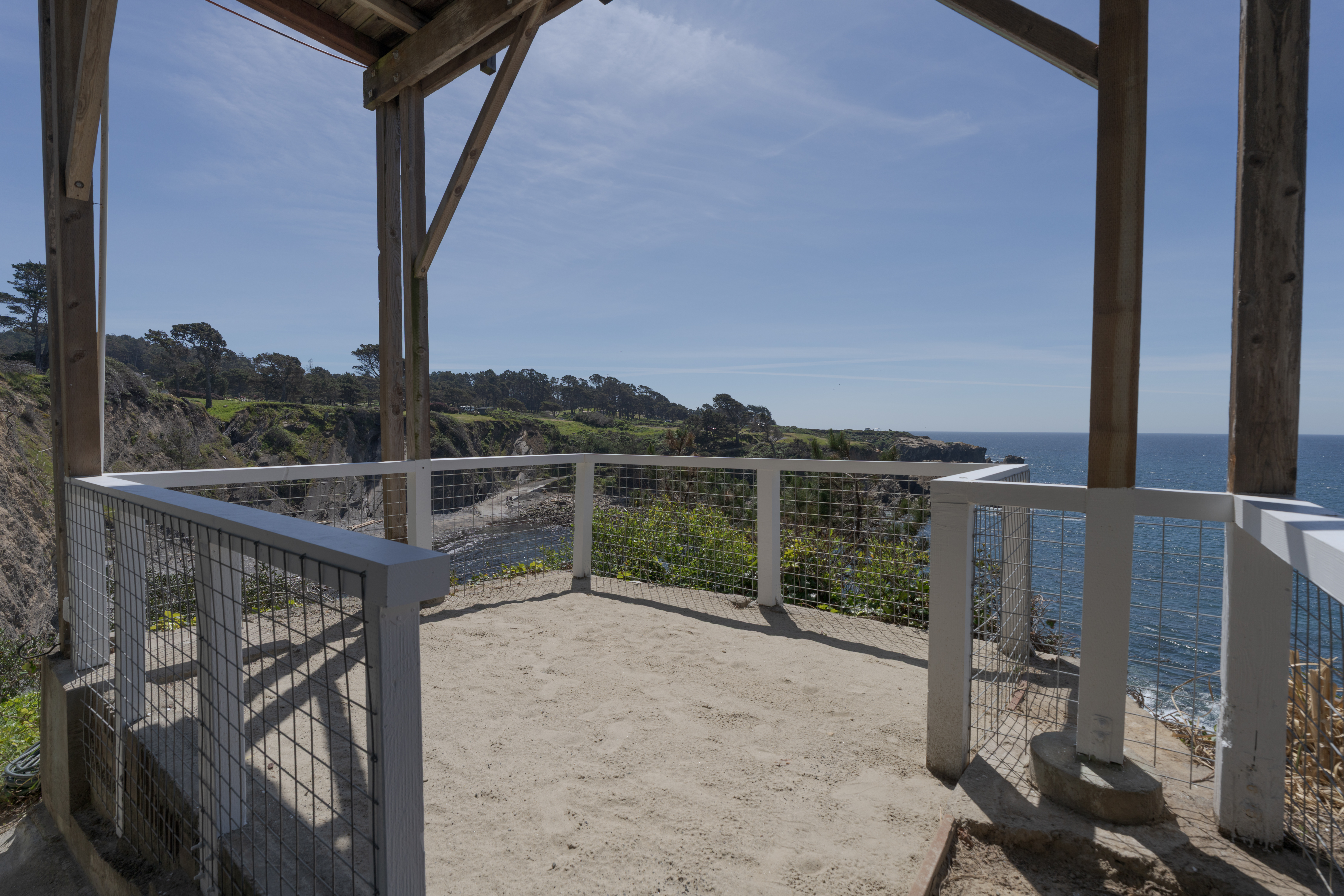 Shaded cliffside deck with panoramic ocean views—perfect for sunsets.