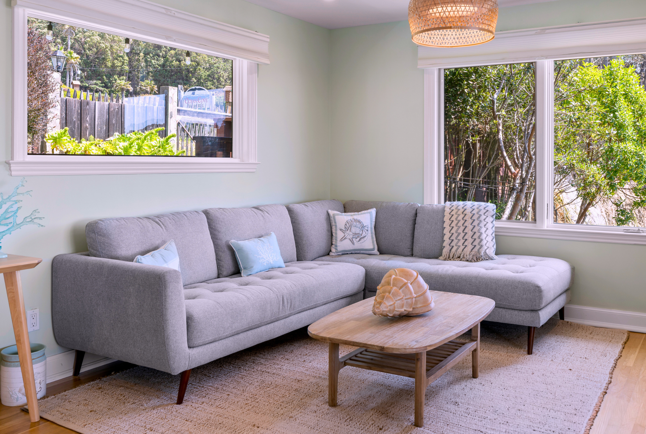 Sunny living room with garden views and a cozy modern sectional