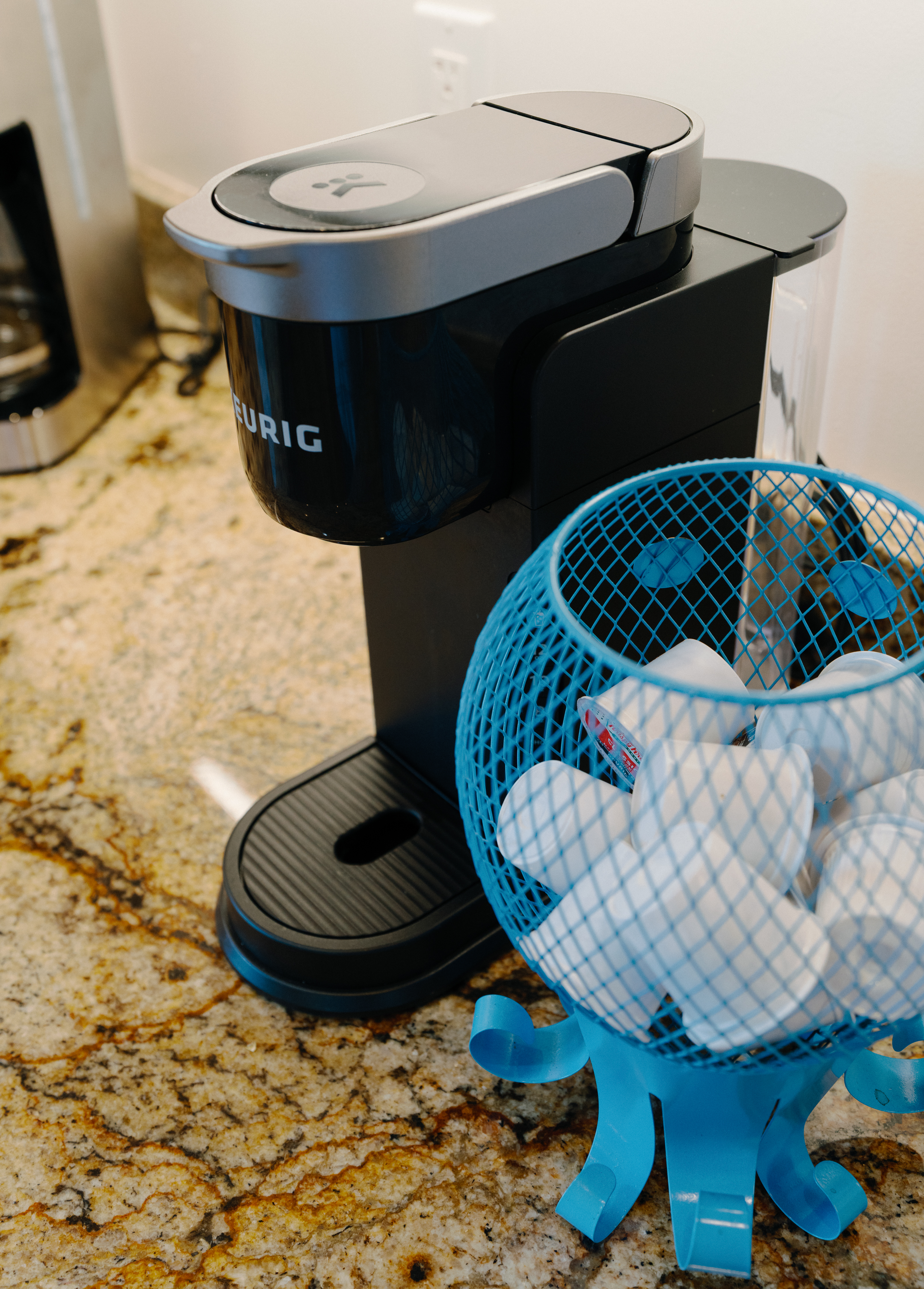 Keurig coffee station with pods on a granite counter—brew in seconds.
