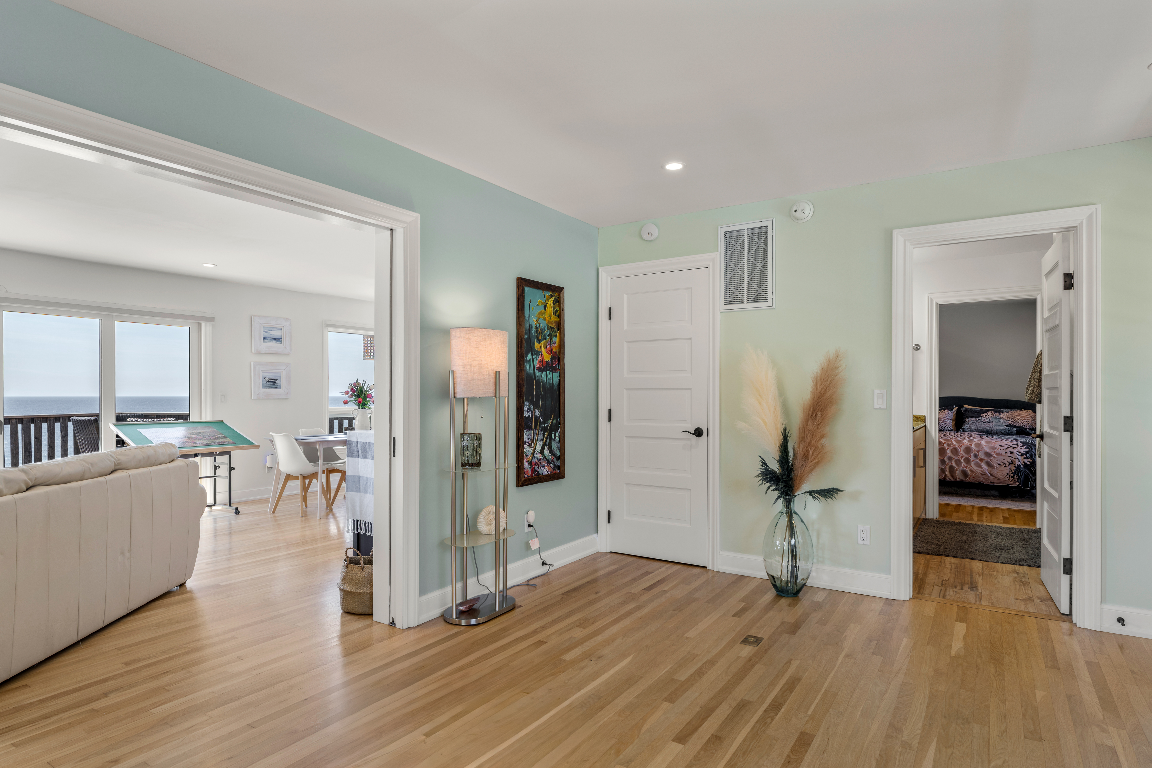 Bright coastal entry with ocean-view living room and hardwood floors