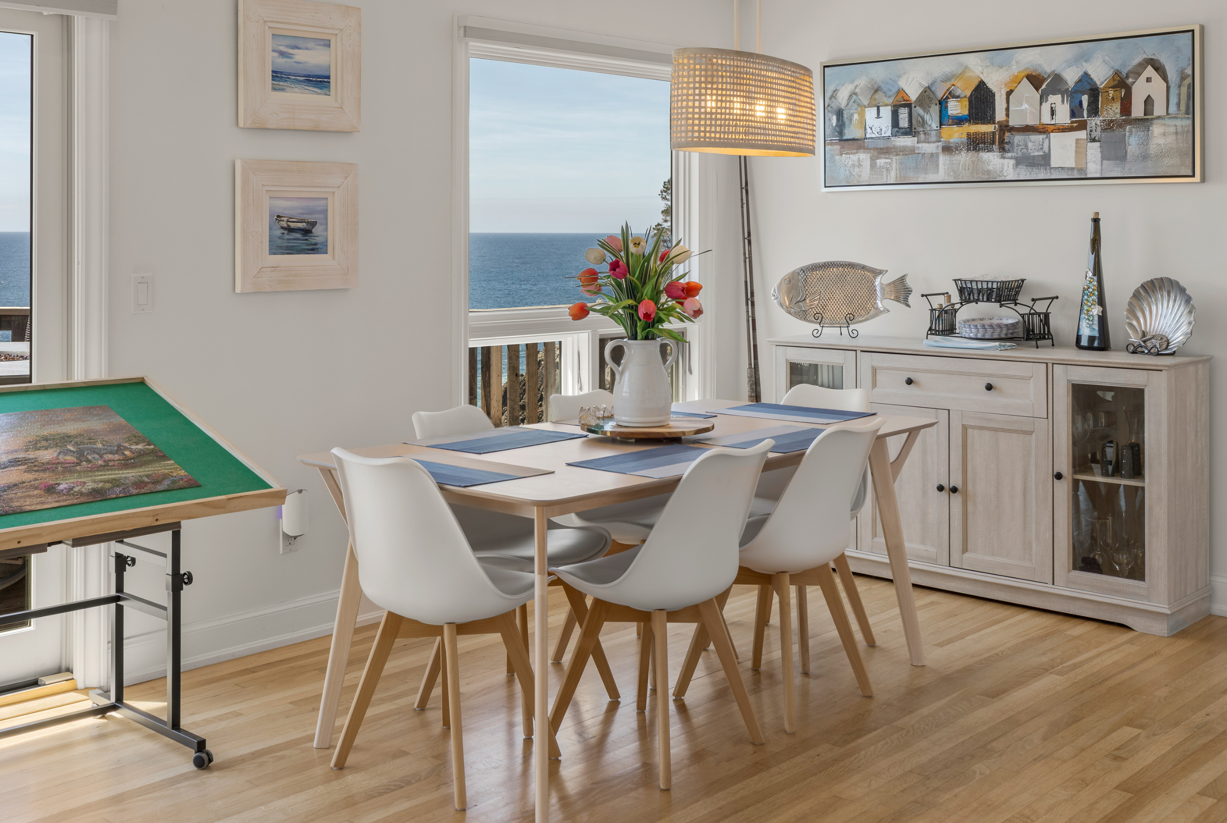 Bright coastal dining space with ocean views and stylish modern decor