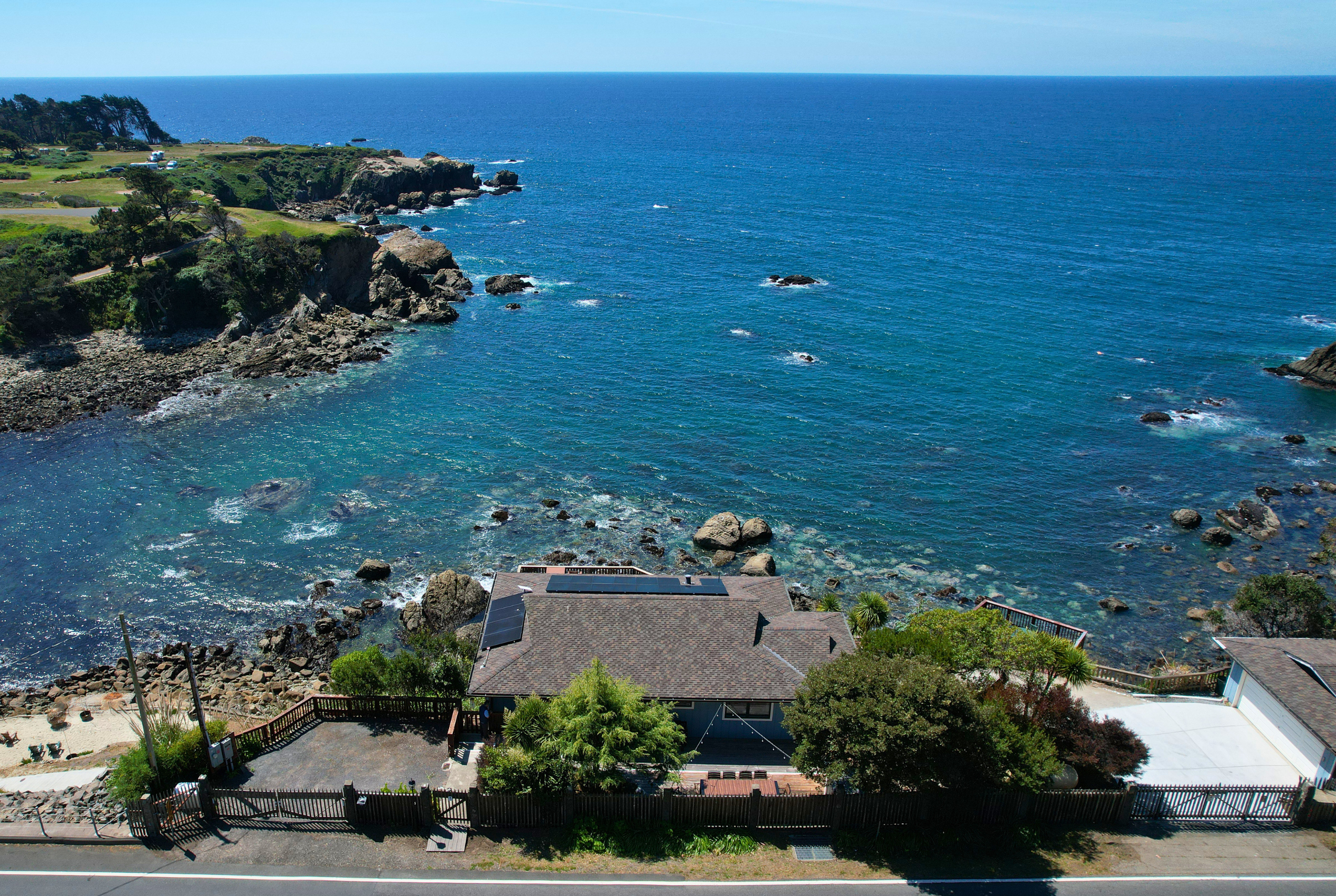 Oceanfront retreat over a rocky cove with sweeping Pacific views and sunsets