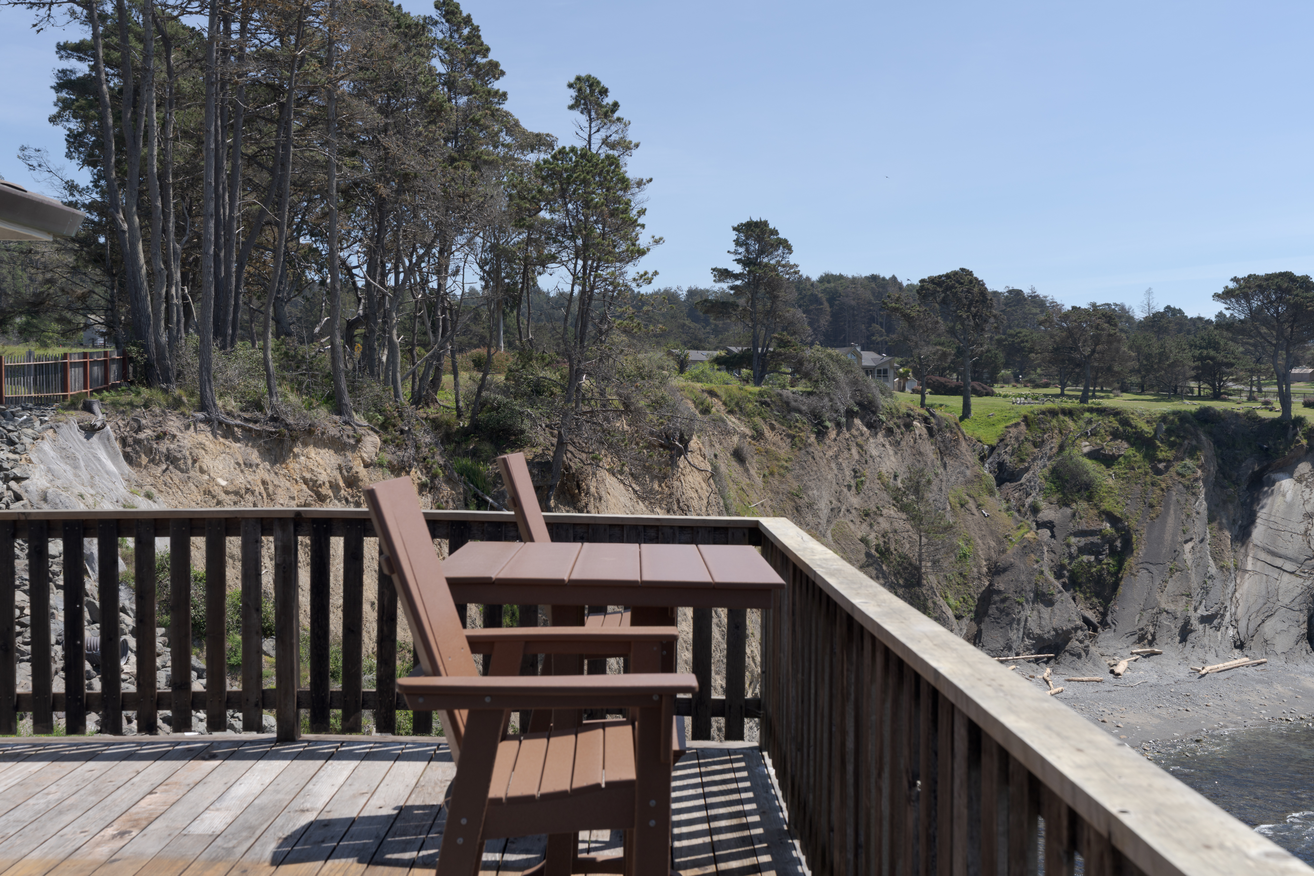 Clifftop deck with ocean cove views—perfect for sunset wine.