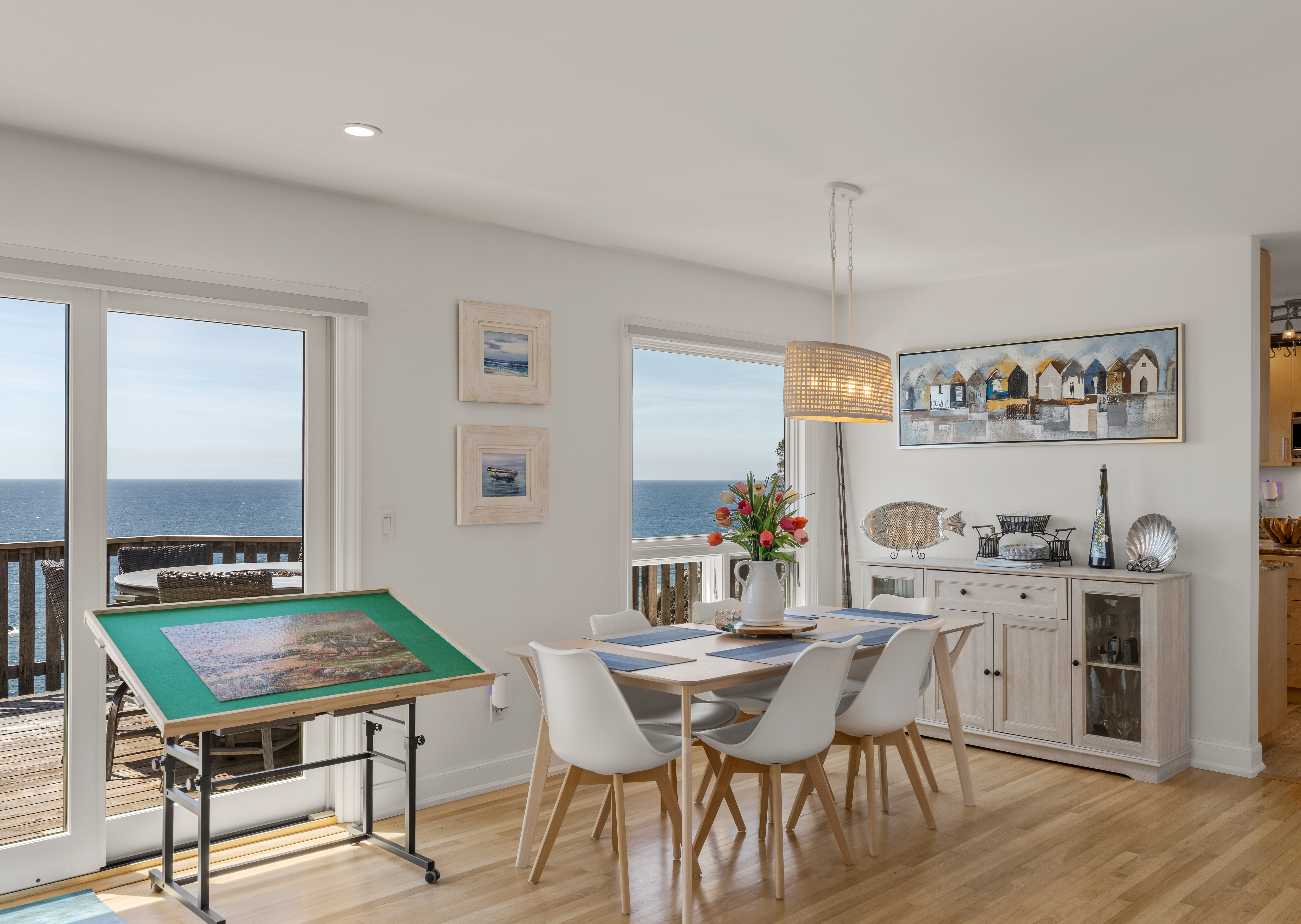 Bright coastal dining with ocean views and sunny deck access