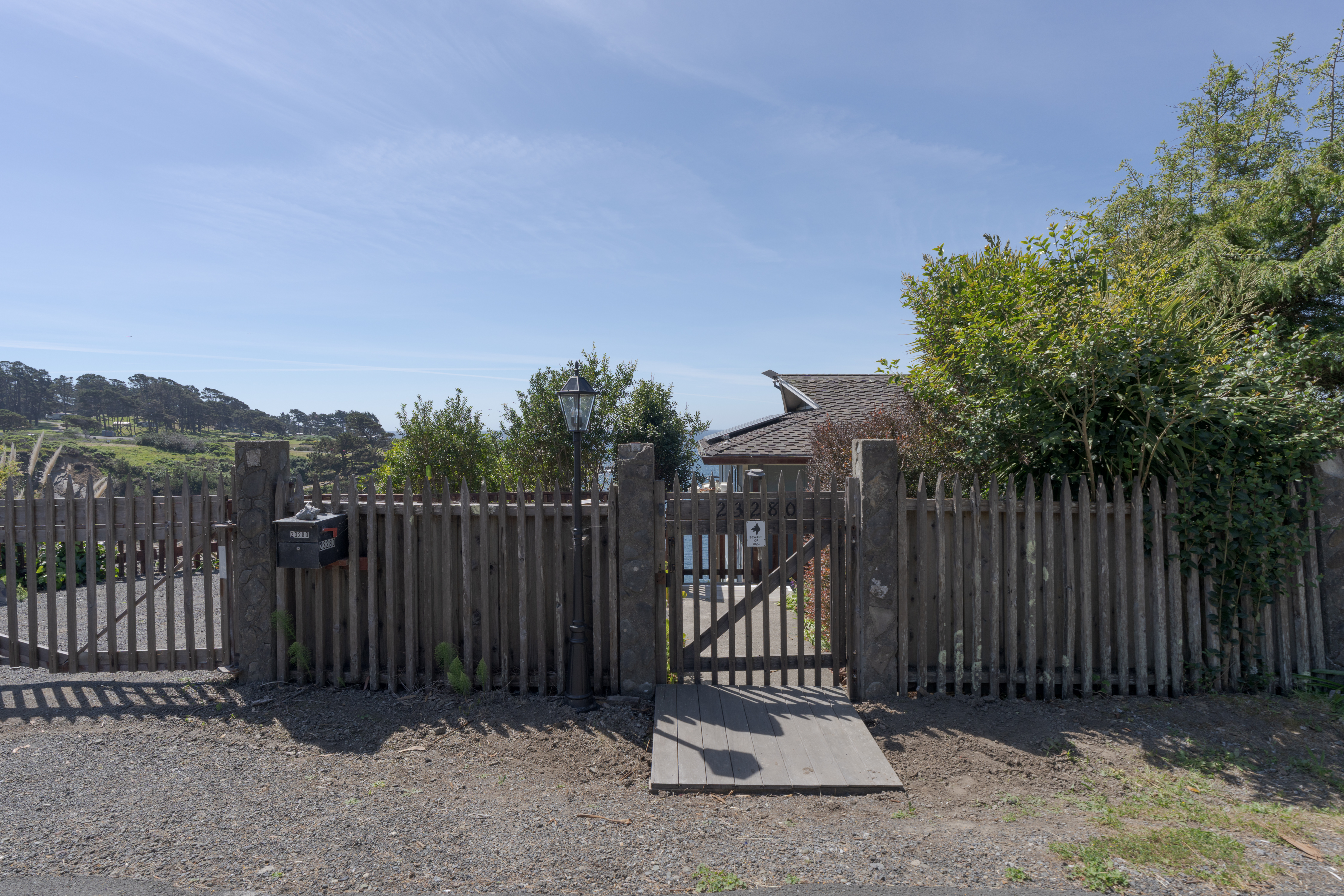 Gated coastal cottage with rustic charm and ocean-view setting