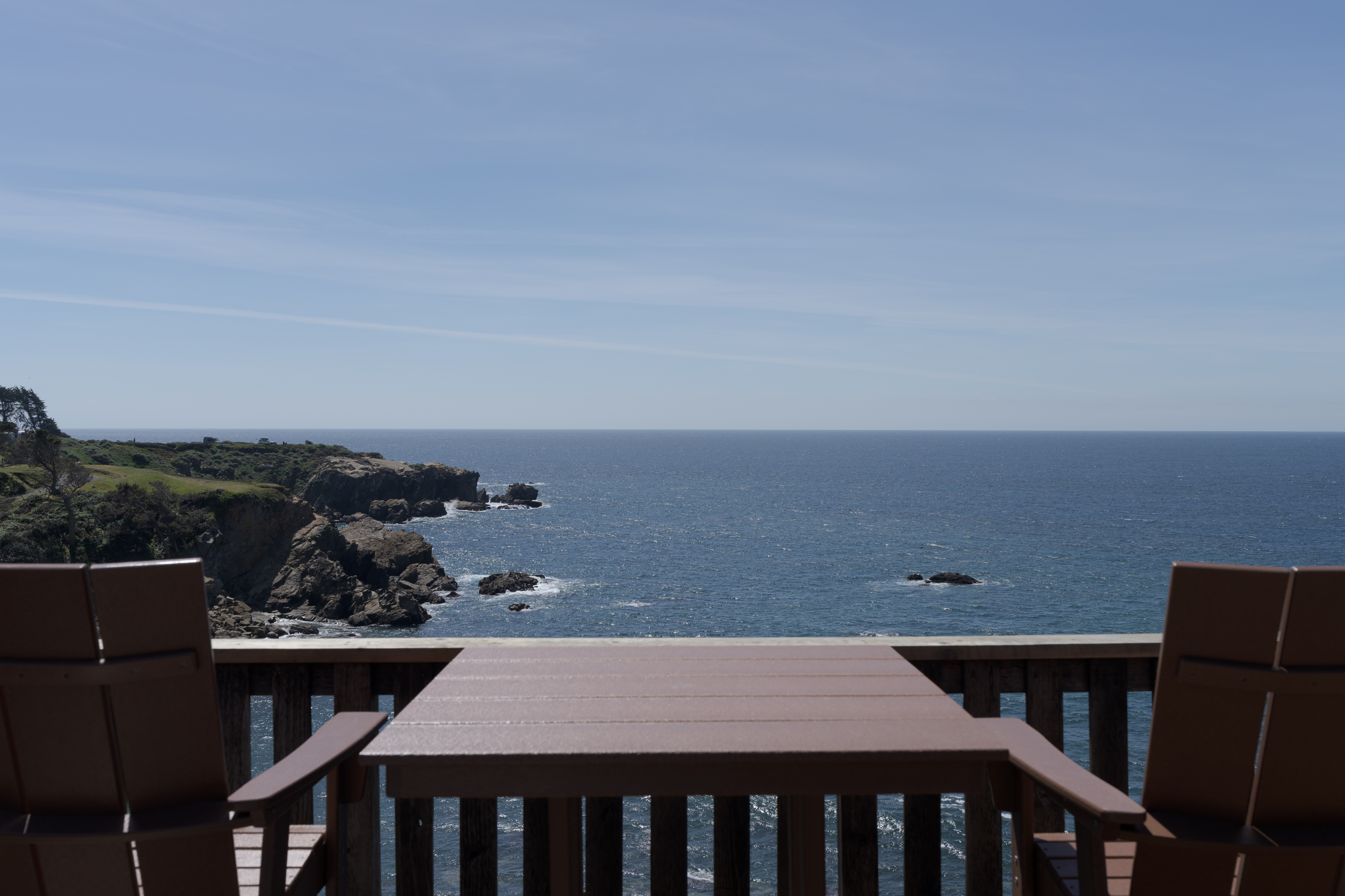 Oceanfront deck with Adirondack seating and endless coastal views.