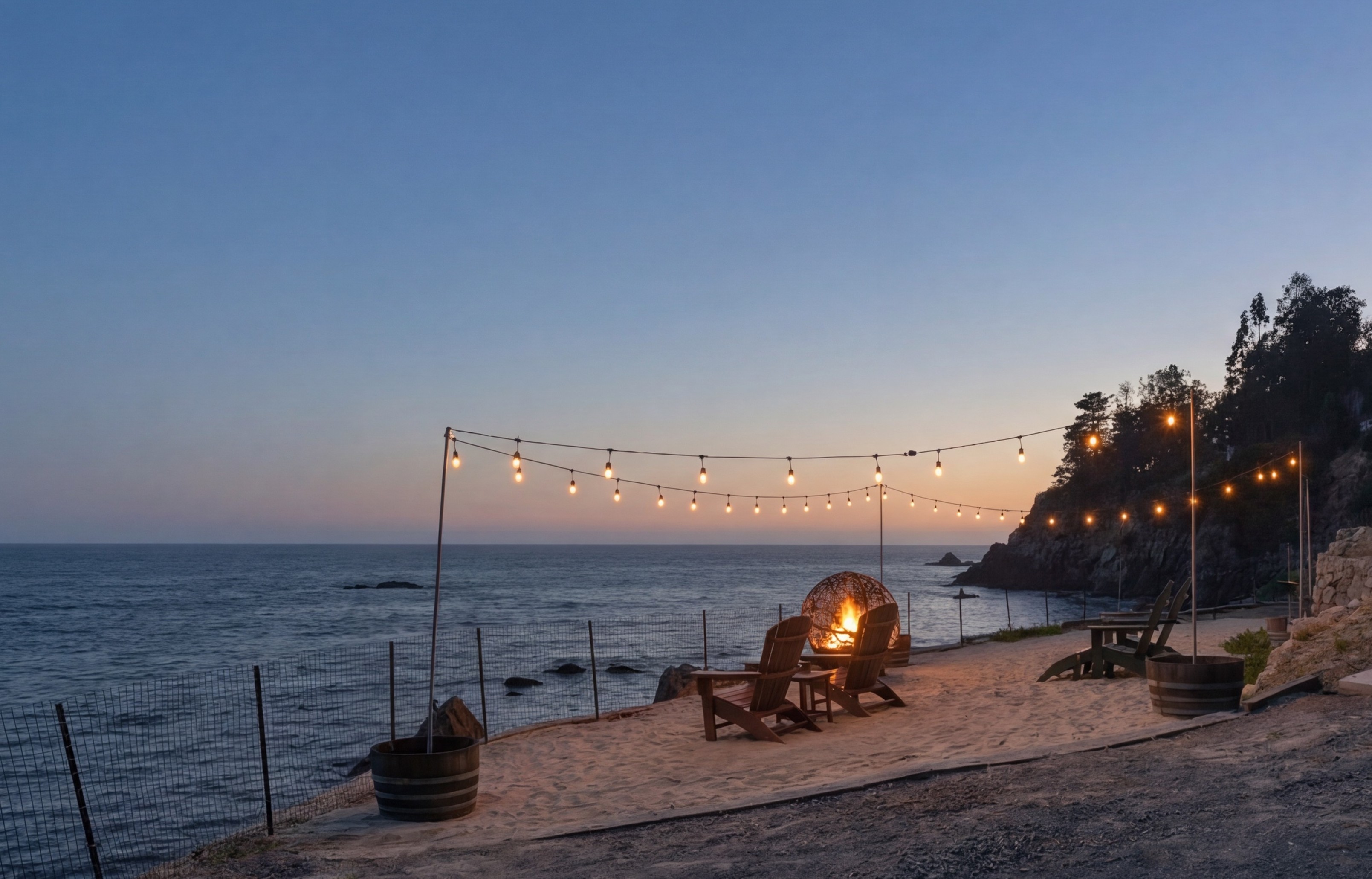 Oceanfront fire pit lounge under string lights with stunning sunset views