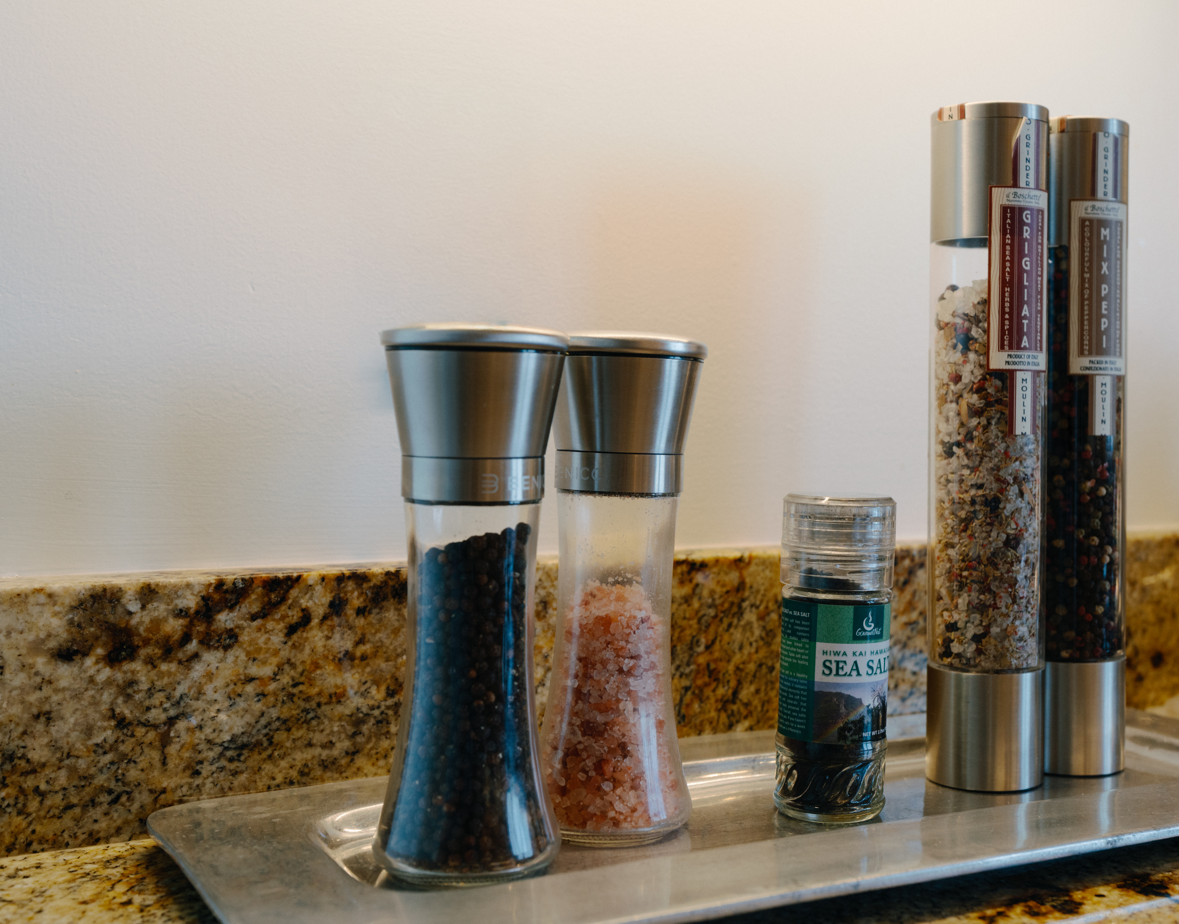 Gourmet-ready kitchen with premium salts and pepper grinders