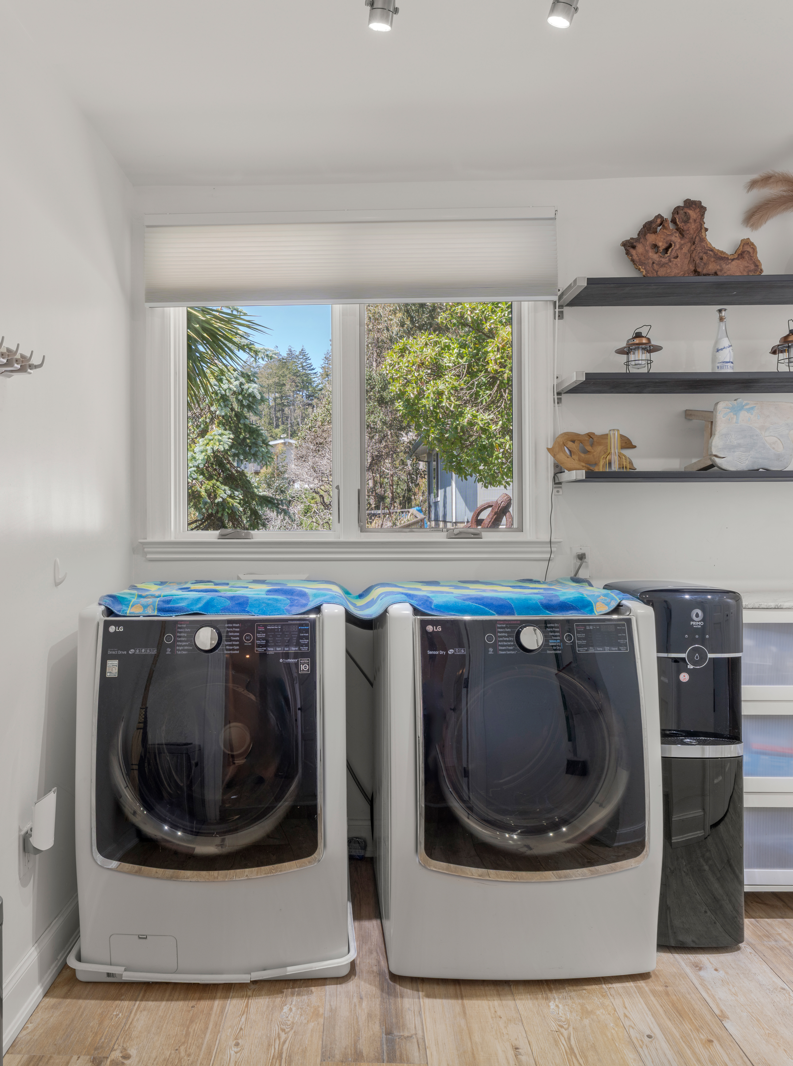 Bright laundry room with modern LG washer/dryer and smart storage