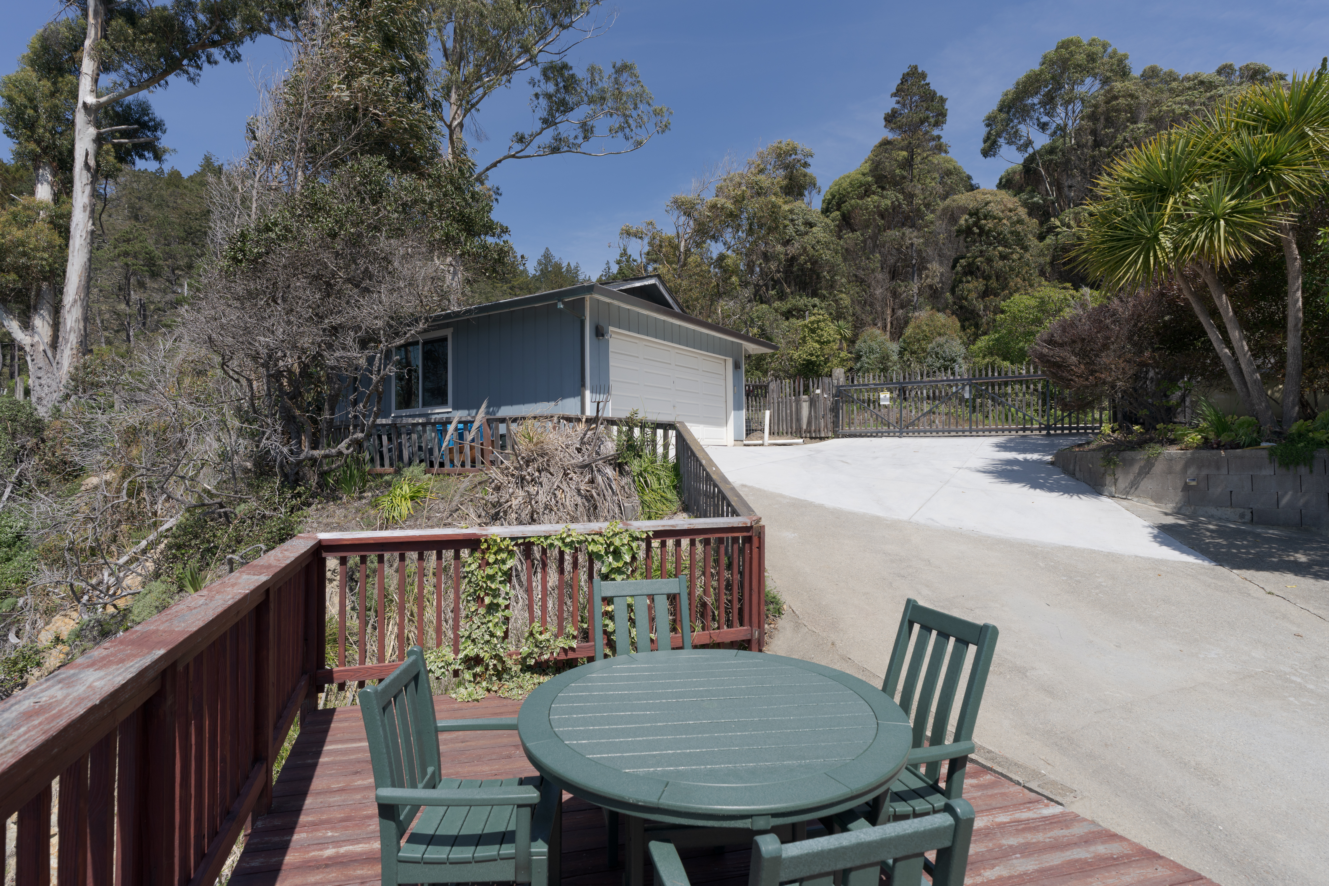 Sunny deck with forest views, gated drive, and easy garage parking.