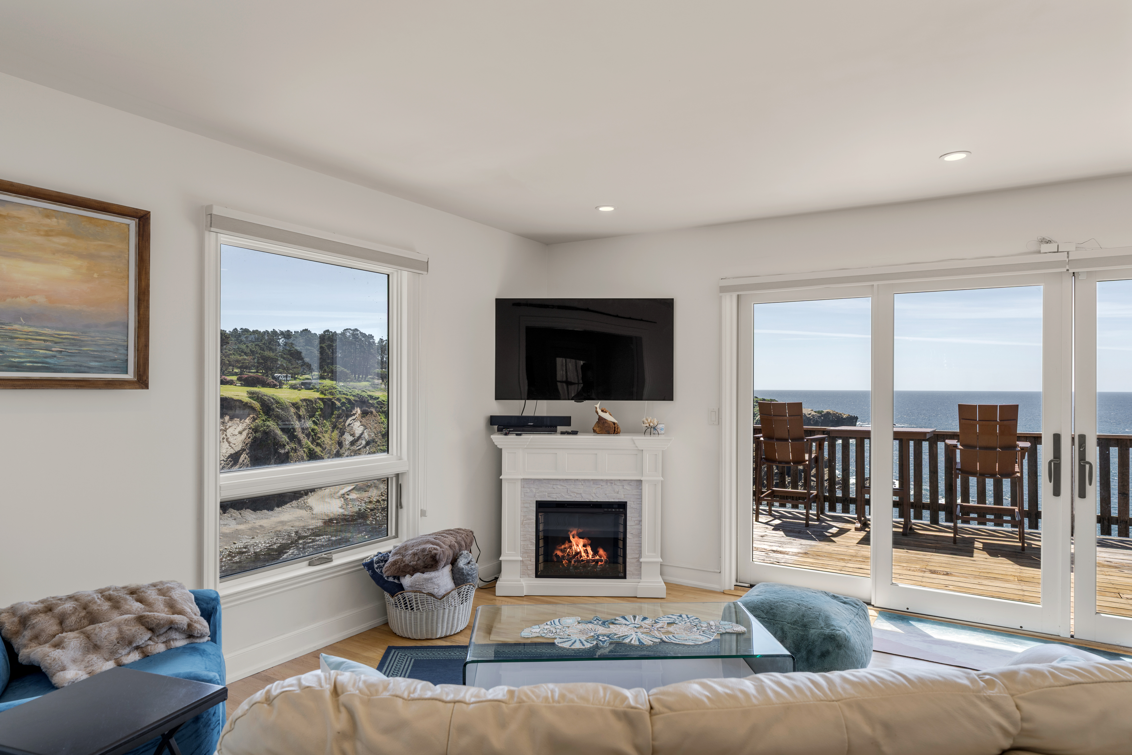 Oceanfront living with deck, fireplace, and sweeping coastal views