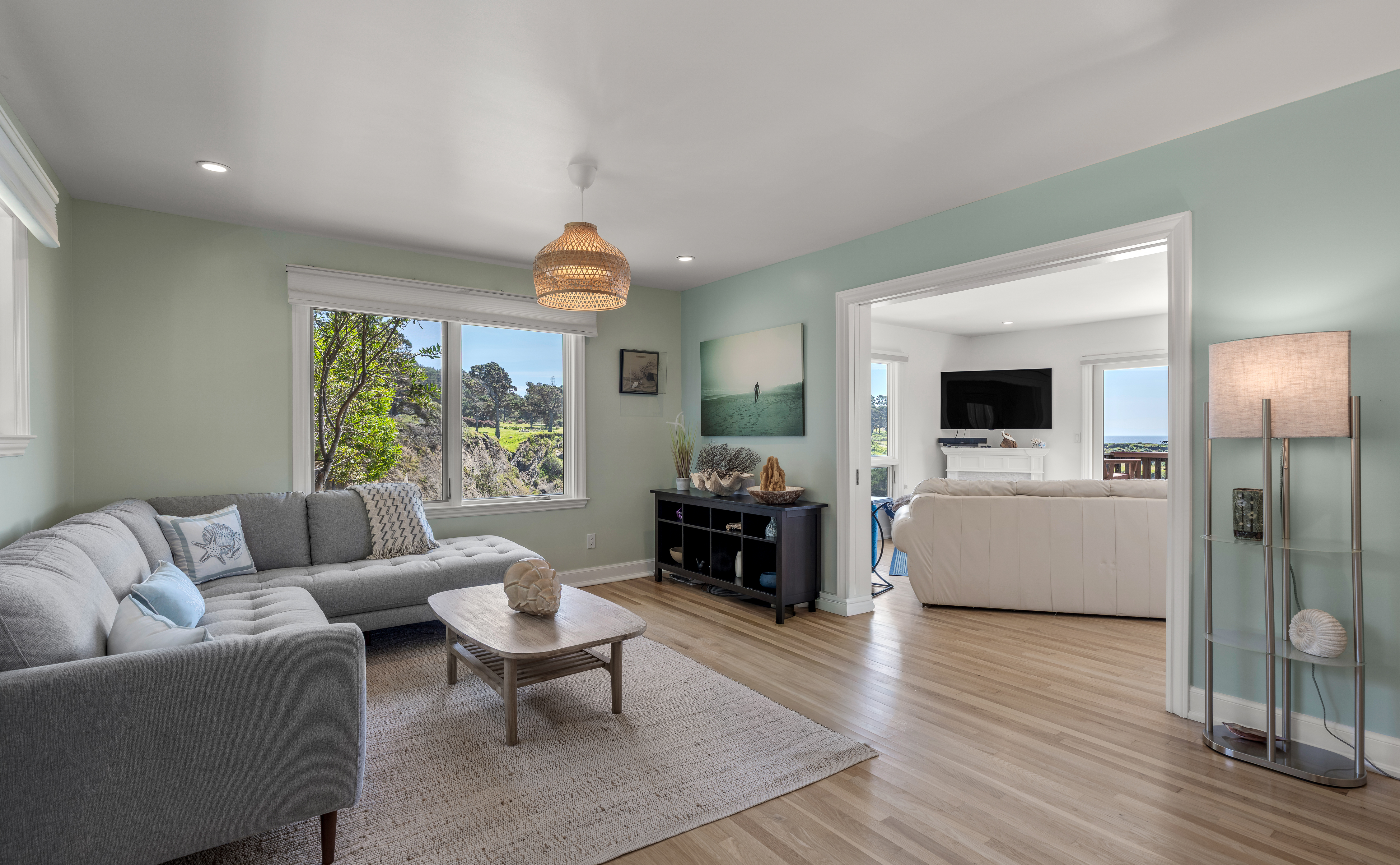 Bright, coastal living spaces with views, open layout, and TV lounge