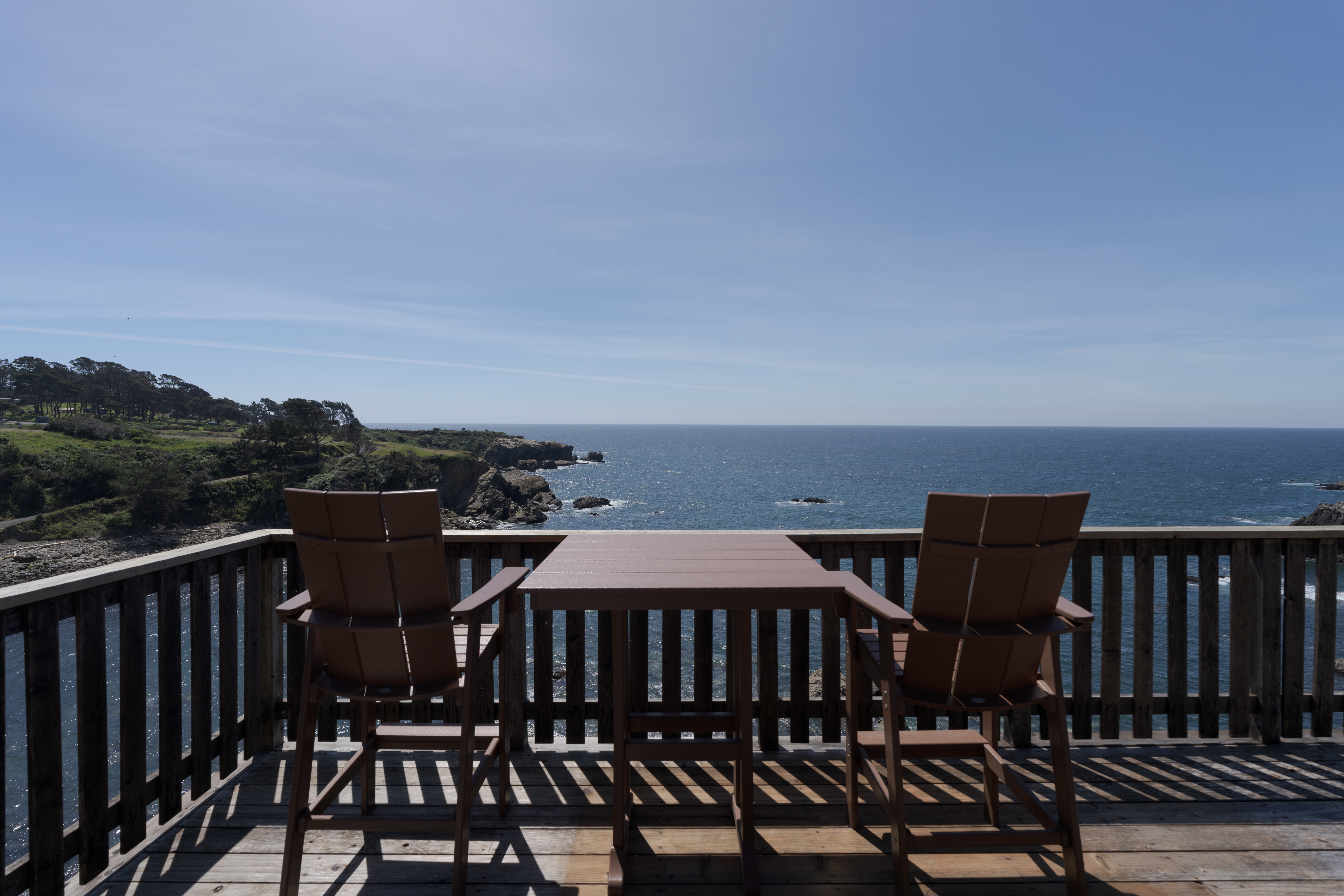 Oceanfront deck with sweeping cliffside views—perfect for sunset dining.