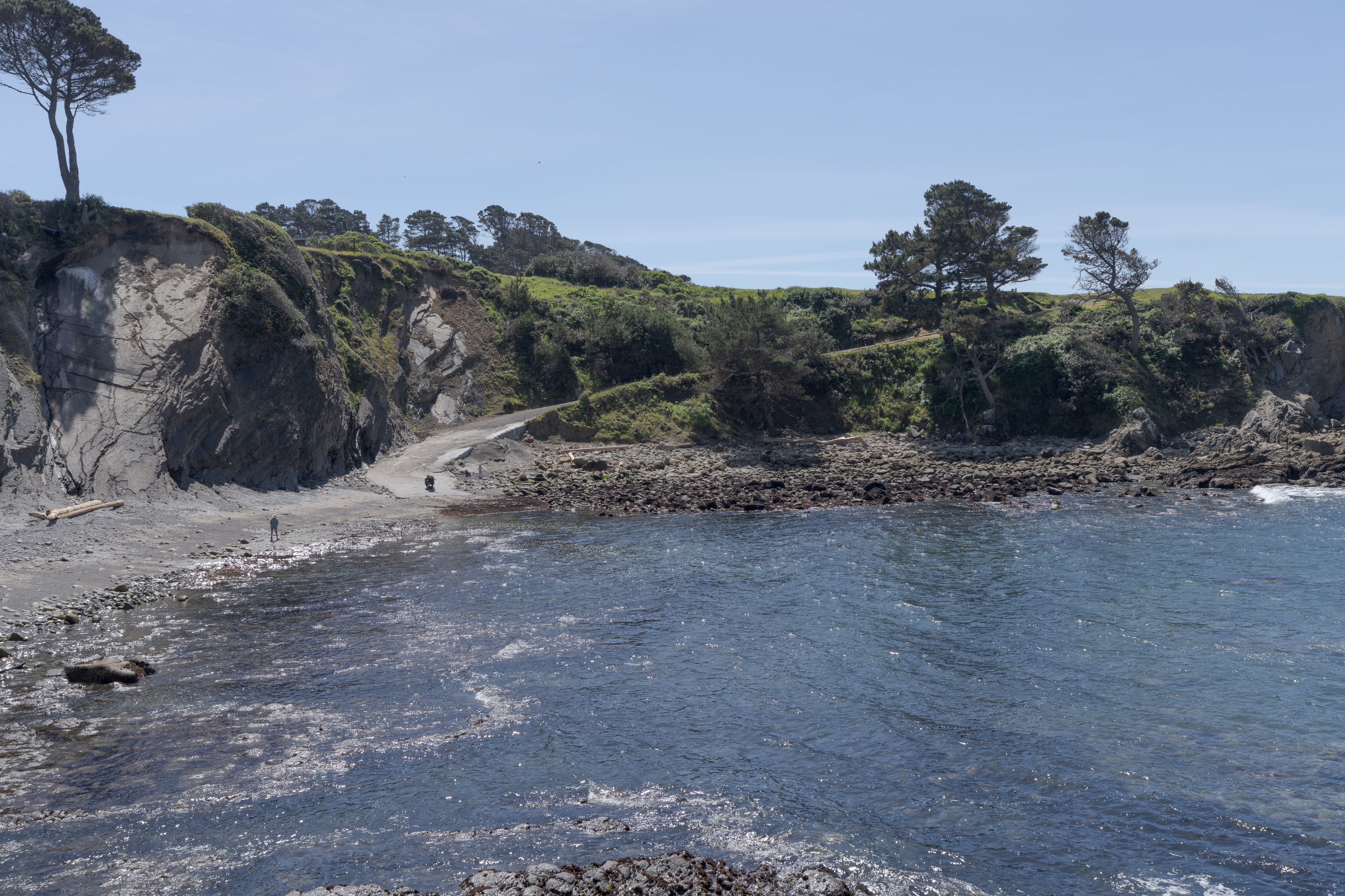 Secluded cove with rocky beach, tide pools, and cliffside trails