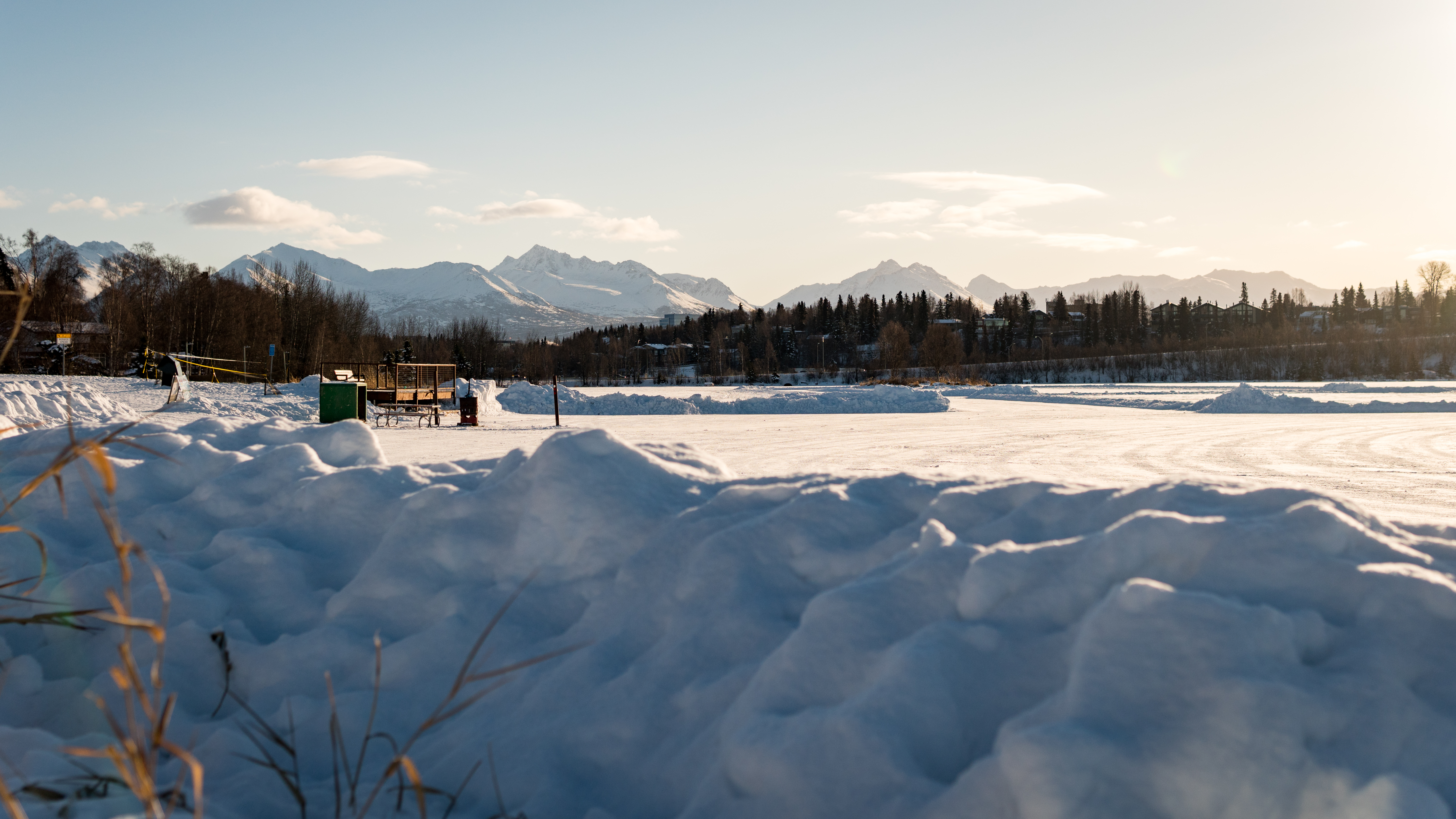 Snowy open space with breathtaking mountain views at golden hour