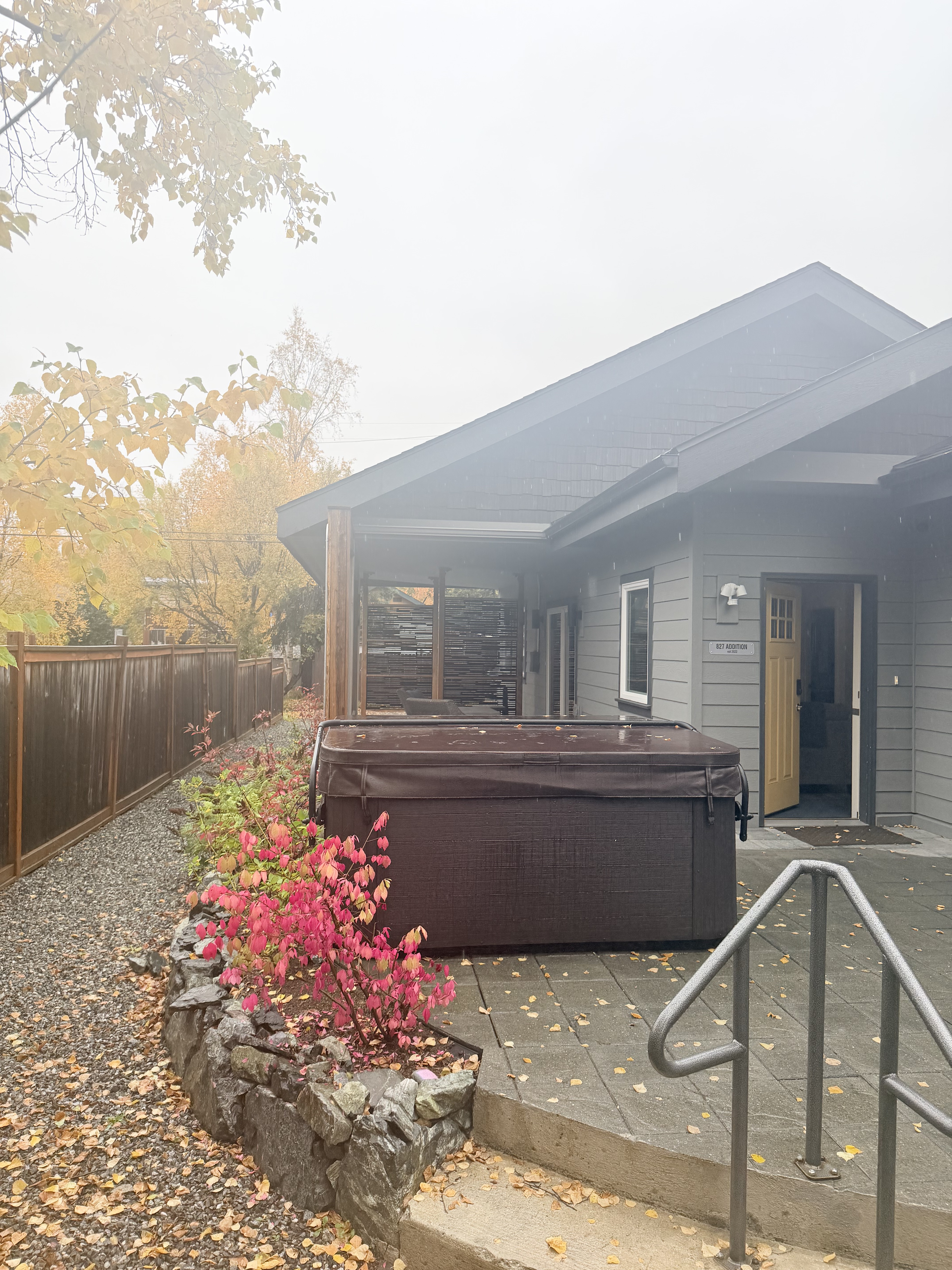 Private outdoor hot tub with cozy patio and peaceful autumn setting