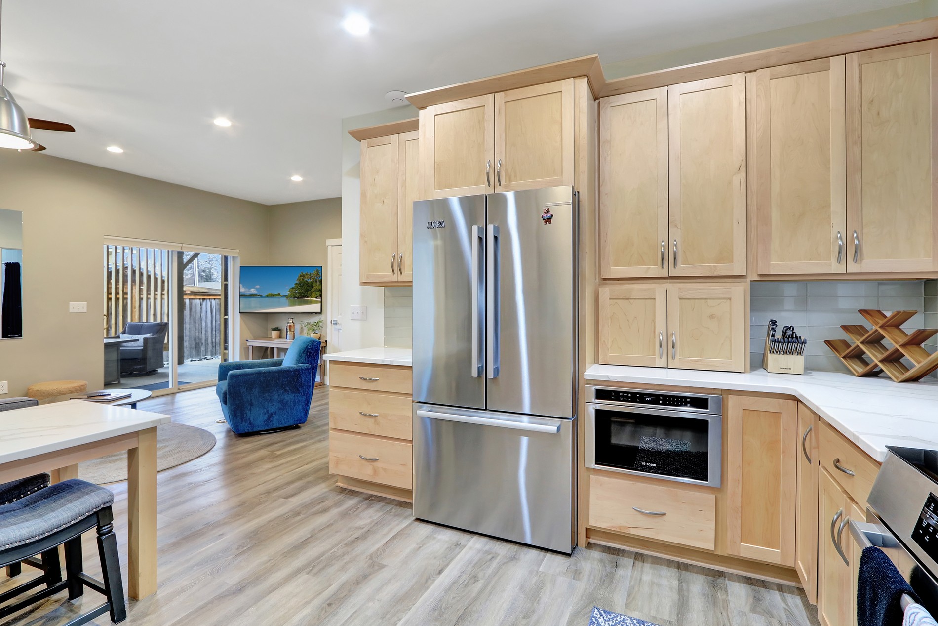 Bright open kitchen with stainless appliances and easy patio access