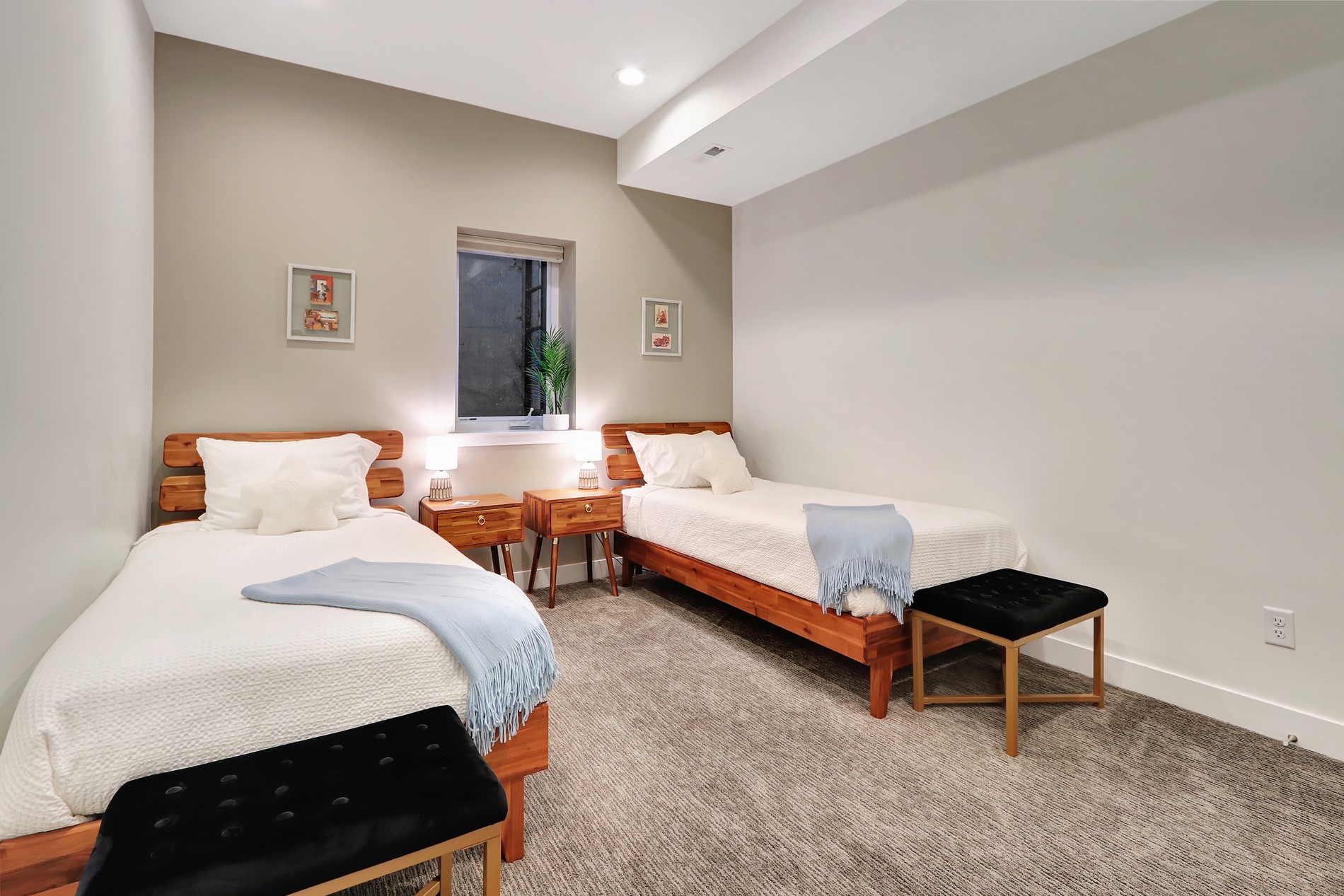 Bright twin bedroom with cozy wood beds and a clean, modern look