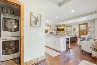 Bright open-plan cabin: stone fireplace, sleek kitchen, in-unit laundry