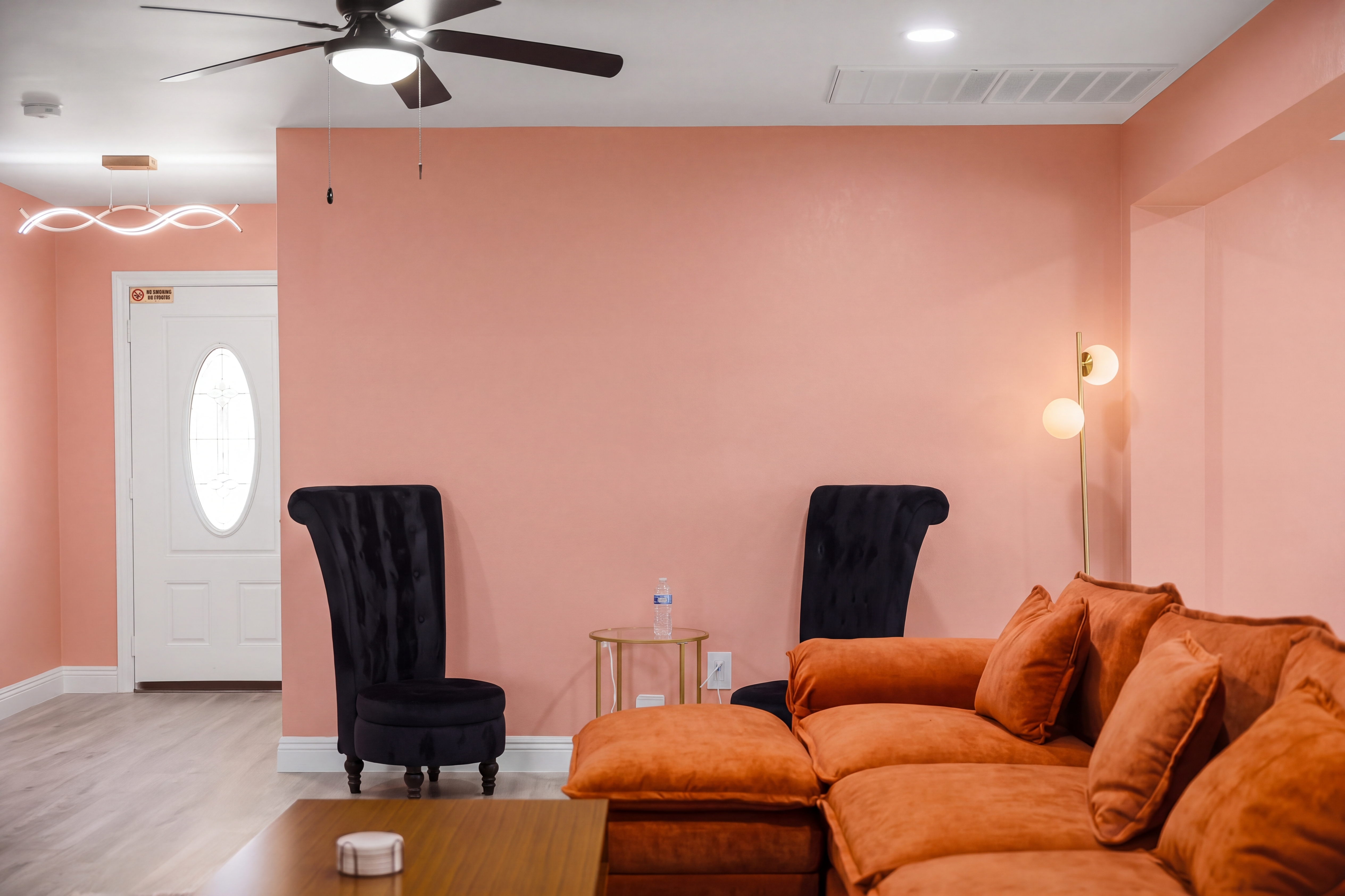Stylish lounge with plush sectional, chic accents, and warm modern vibes