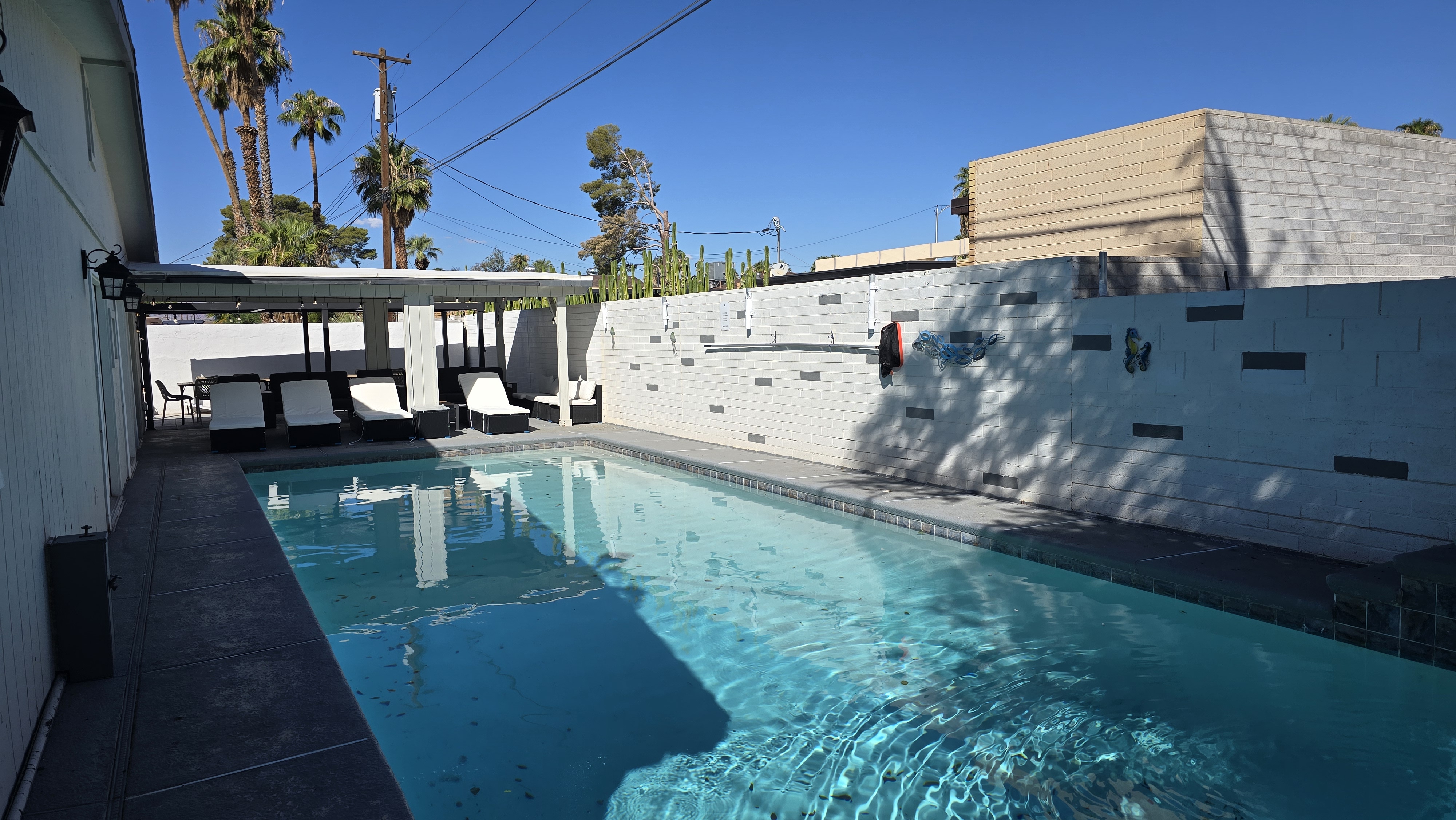 Private pool with shaded loungers and a sleek modern outdoor retreat