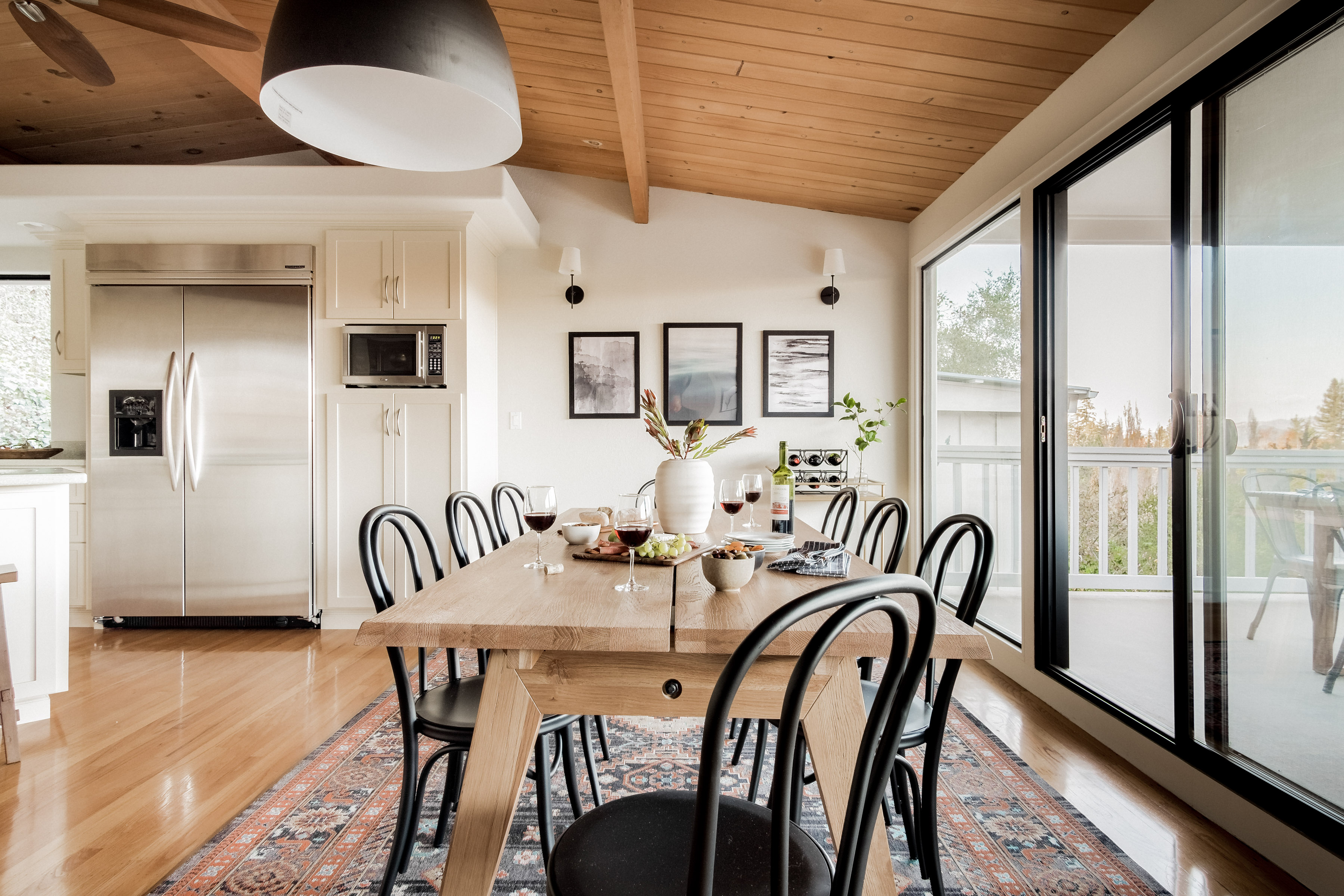 Bright dining space with balcony access and seating for 8