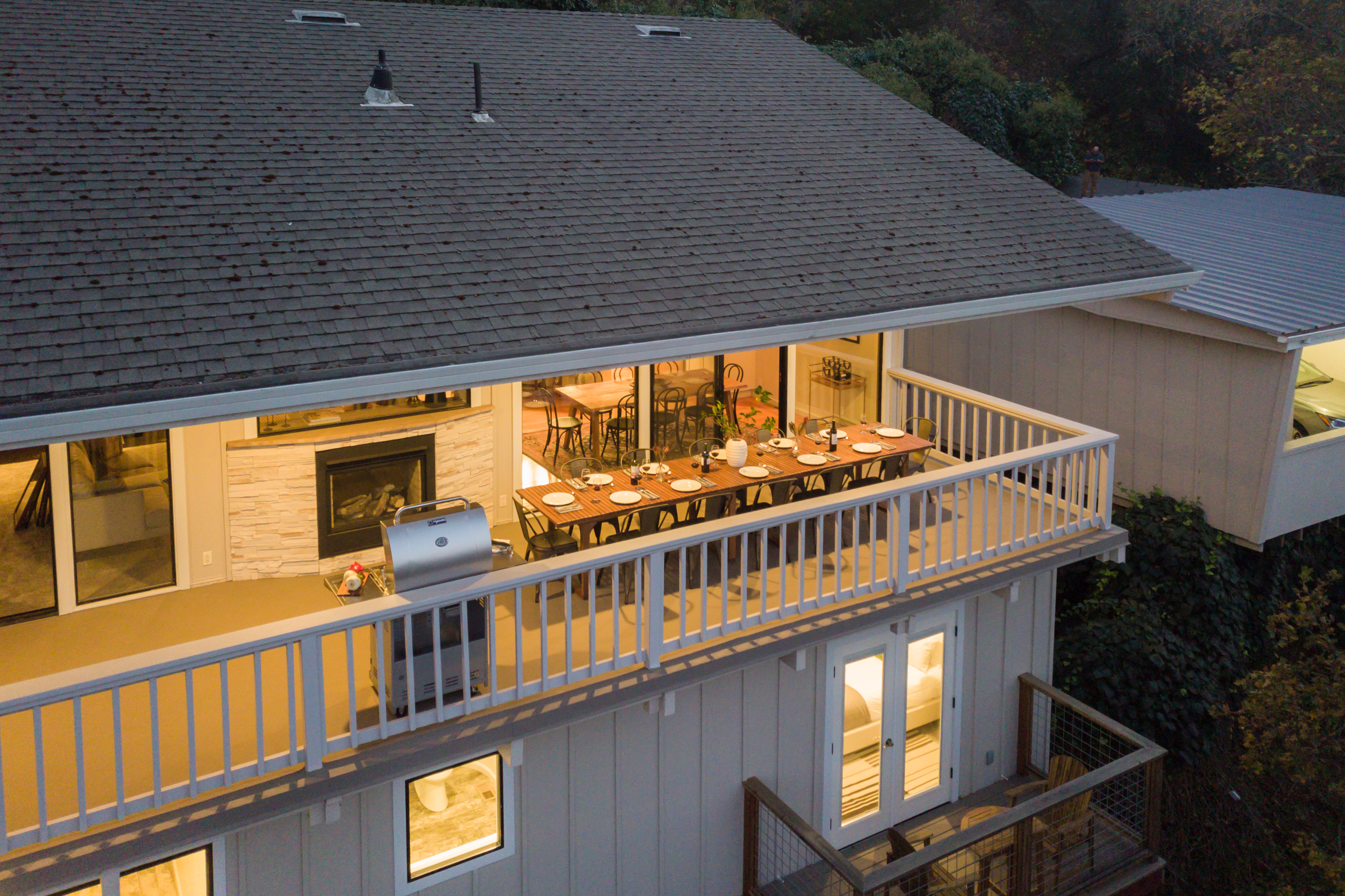 Covered deck with fireplace, grill, and outdoor dining for the whole group