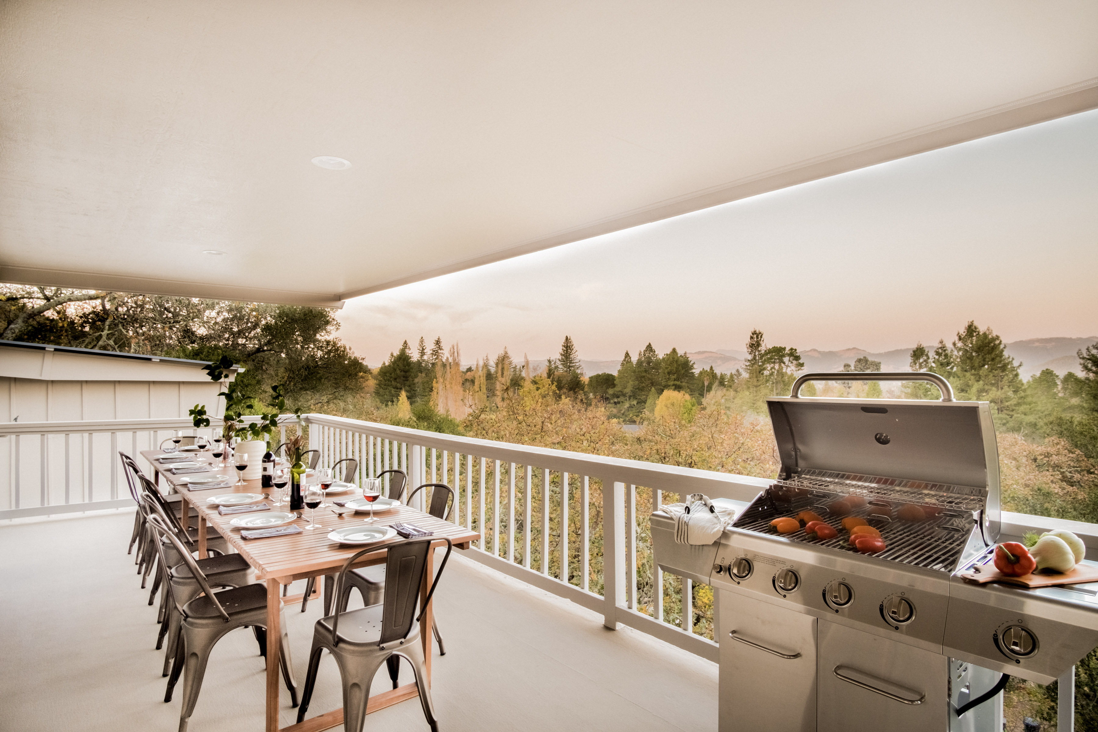 Covered view deck with outdoor dining and grill for memorable group meals
