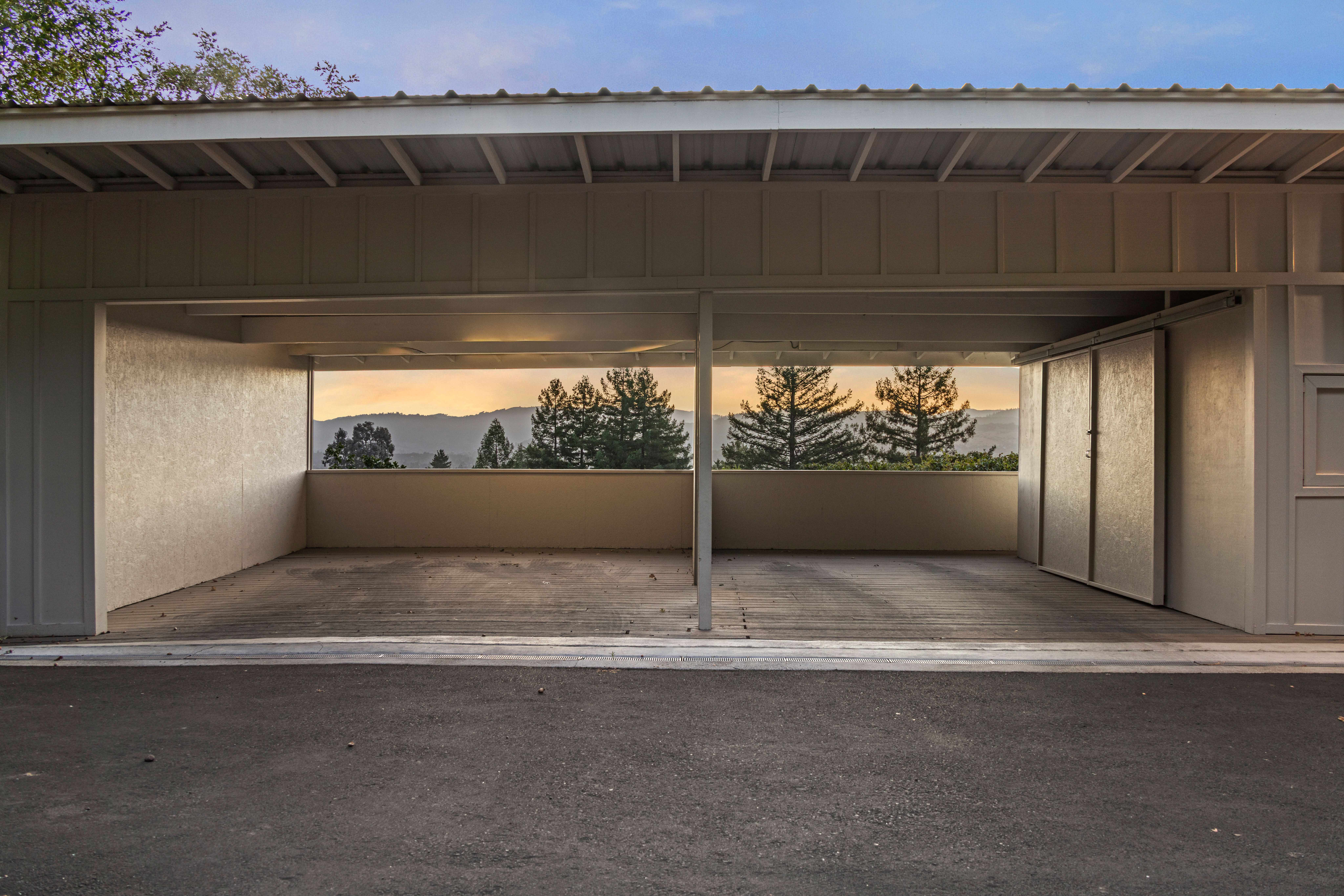 Spacious covered parking with peaceful treetop and hillside views