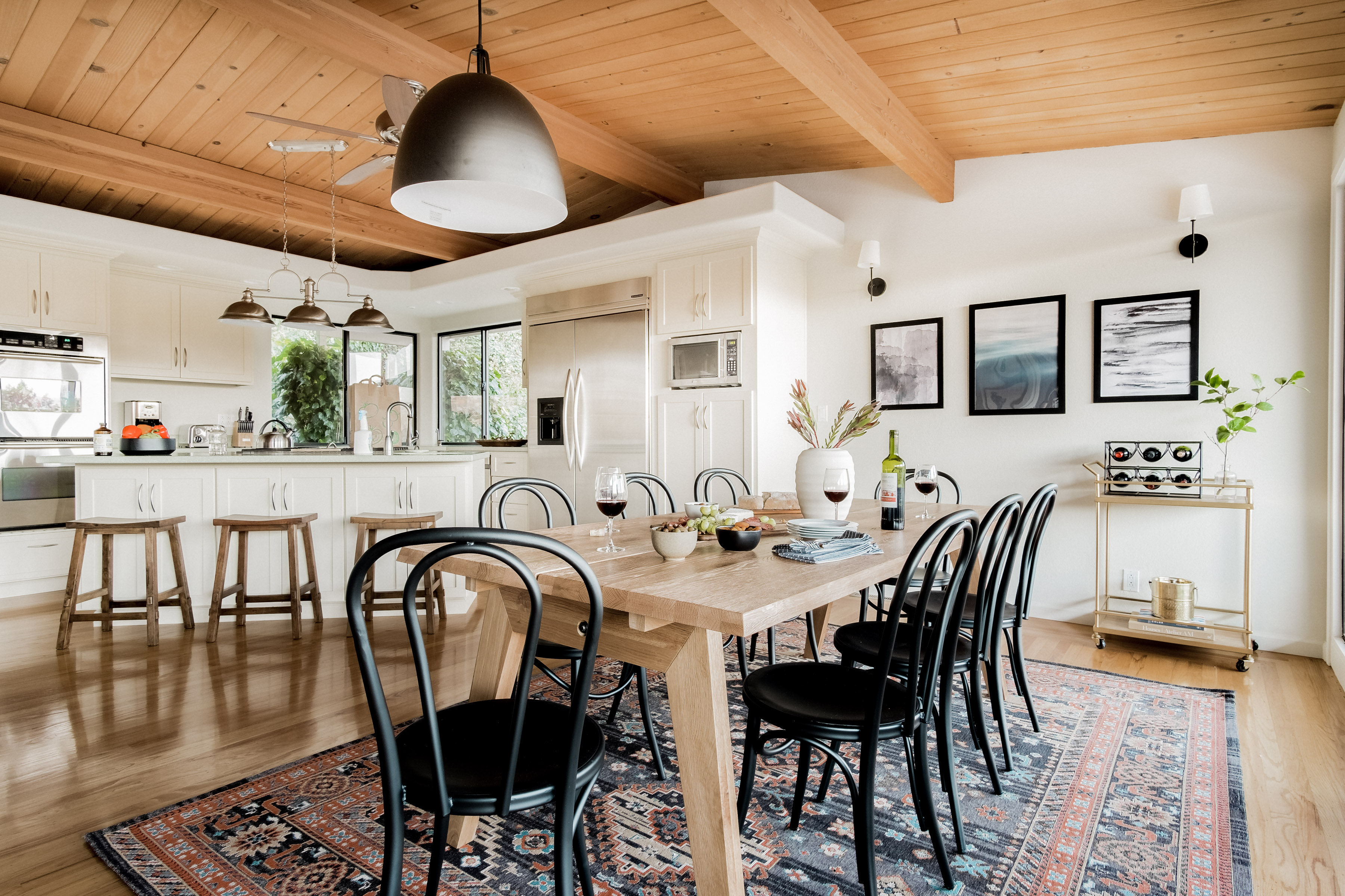 Bright open kitchen and dining space with warm wood details and seating for 6