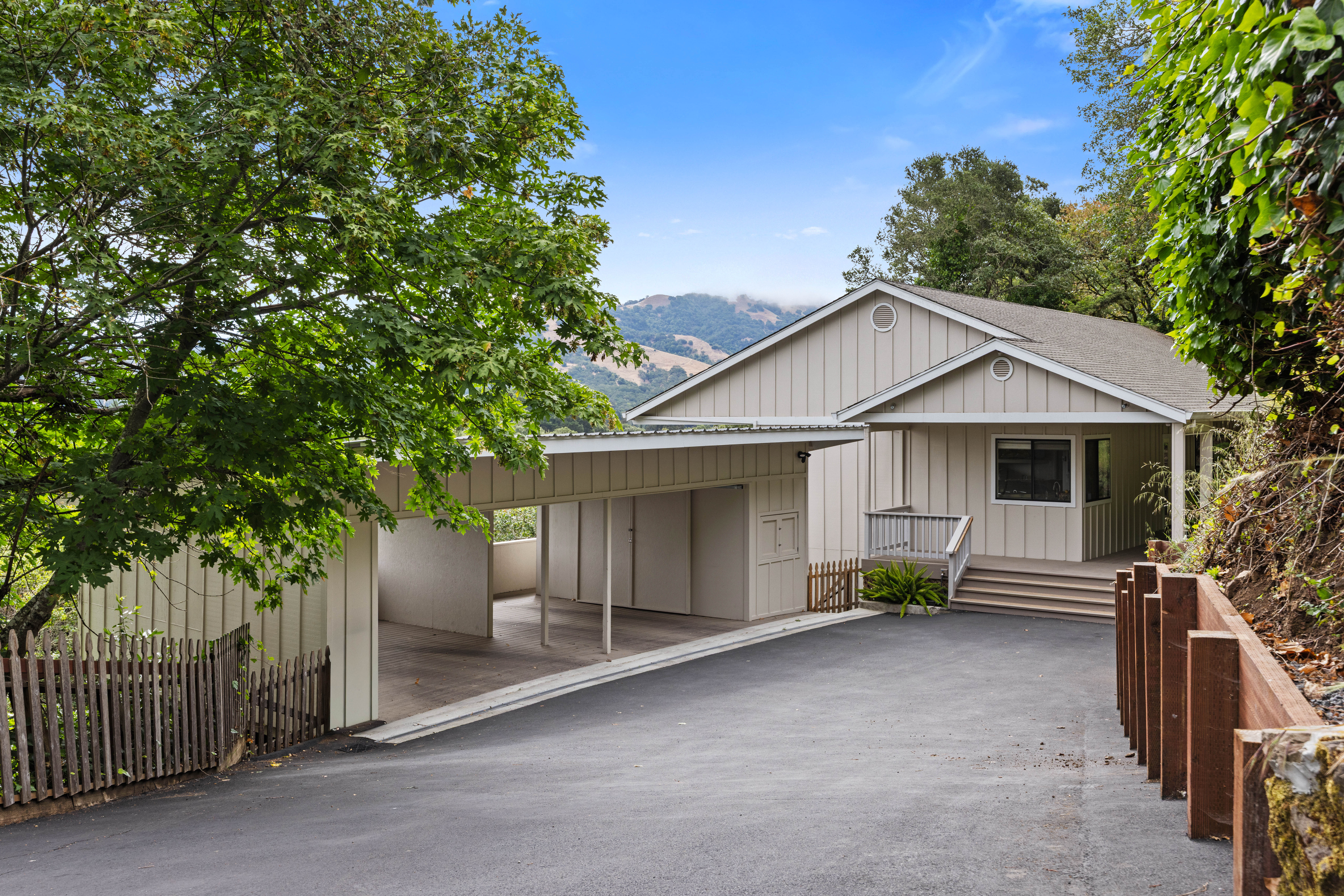 Private hillside retreat with carport, mountain views, and lush surroundings