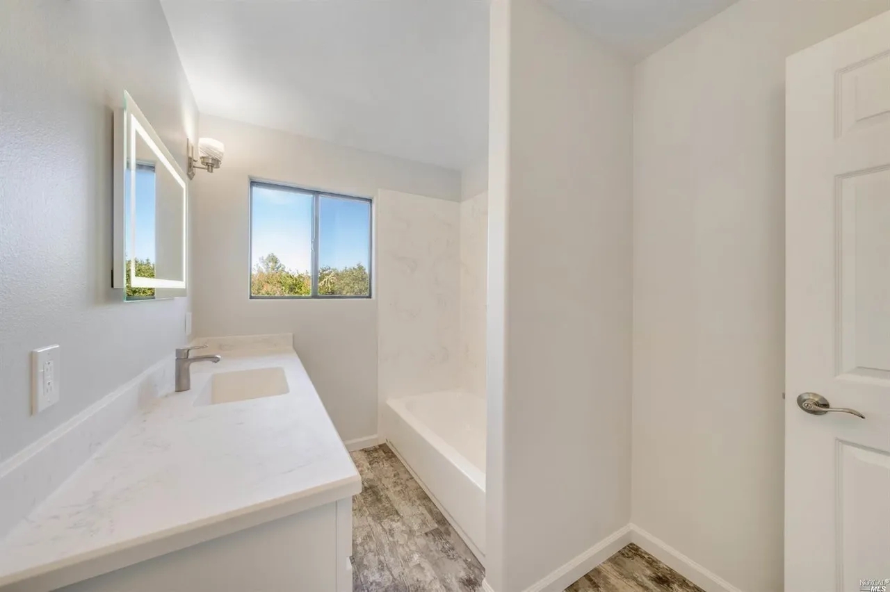 Bright, modern bath with quartz vanity and tub/shower combo
