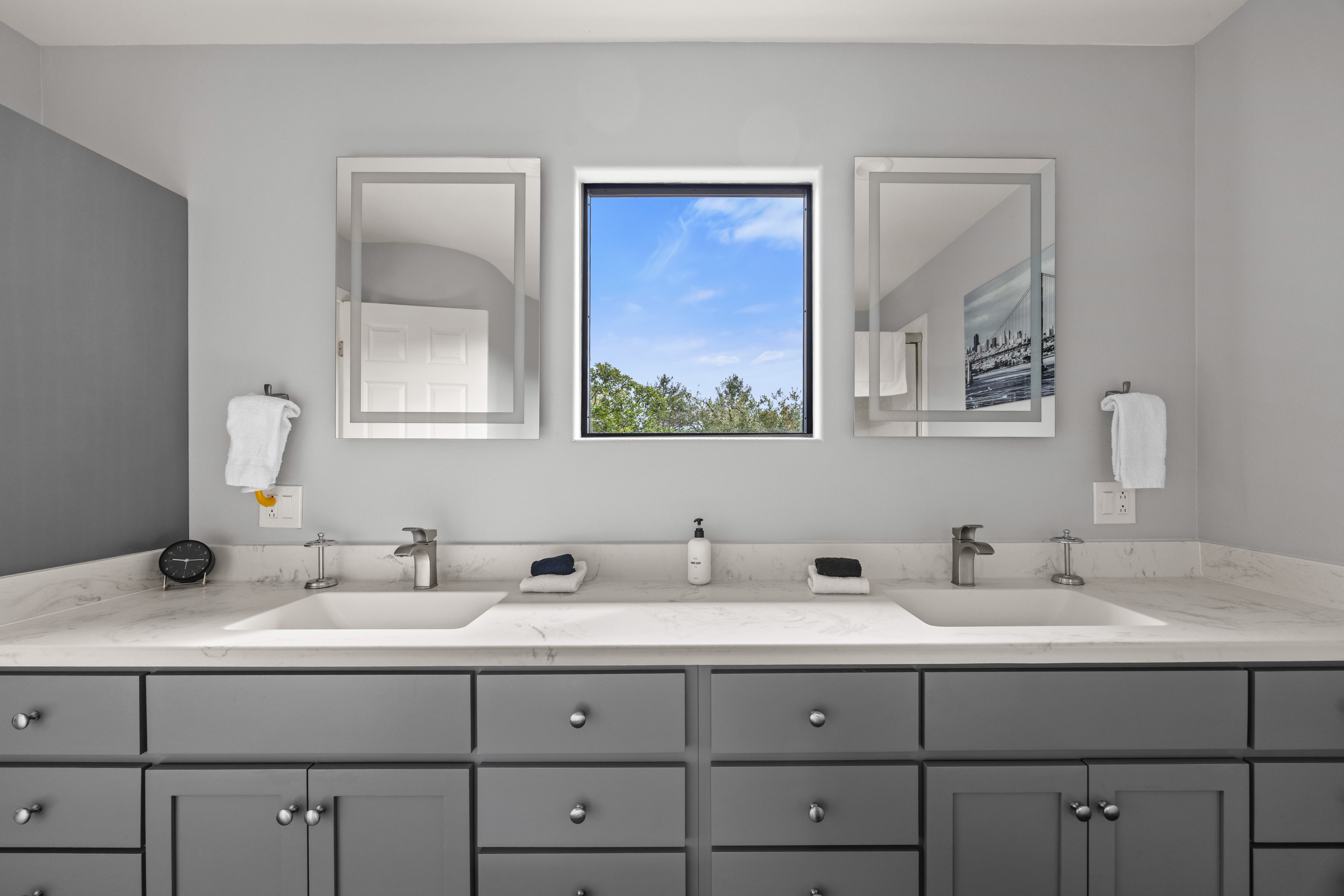 Bright double vanity bathroom with modern finishes and natural light