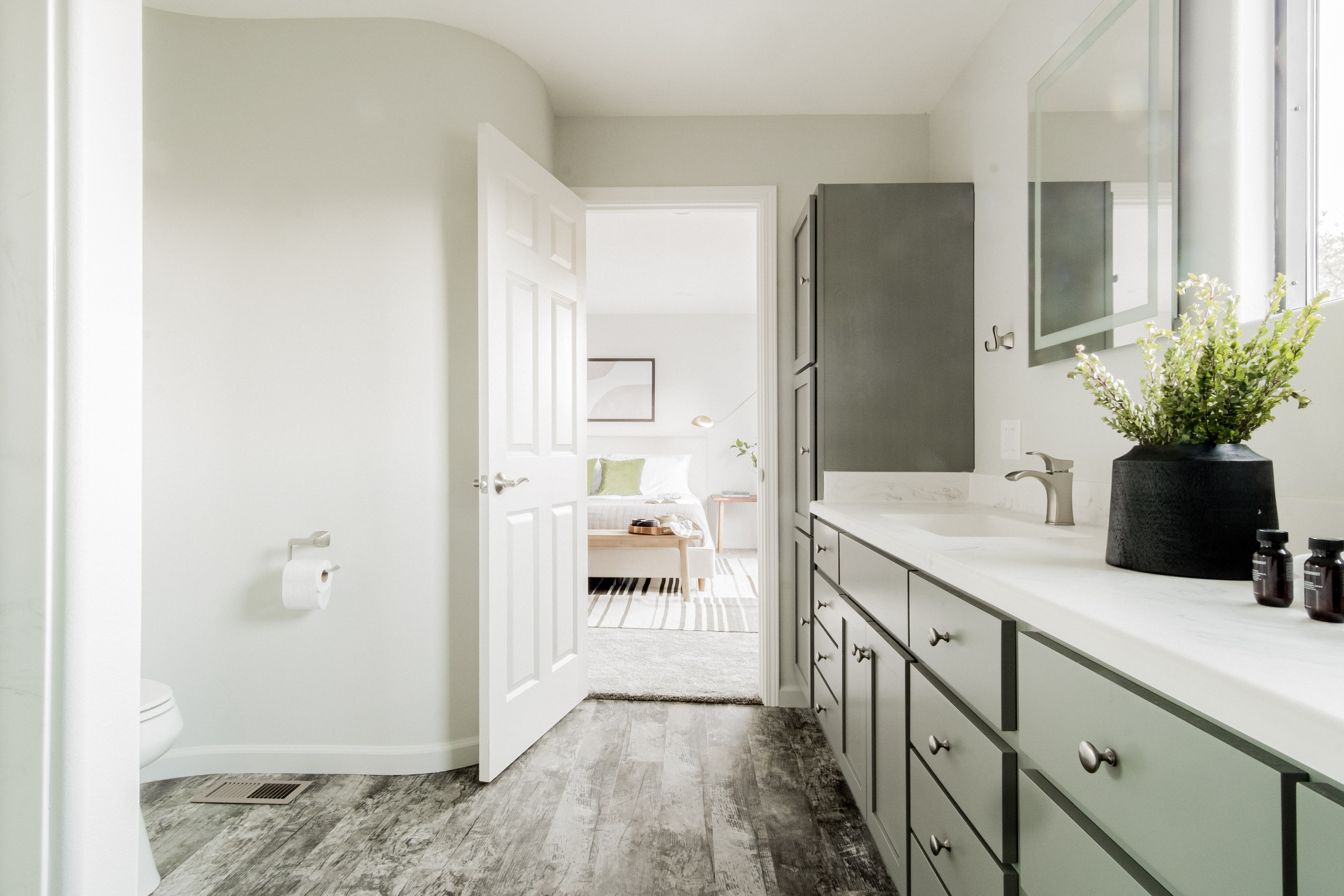 Bright spa-like bathroom with dual vanity, natural light, and modern finishes
