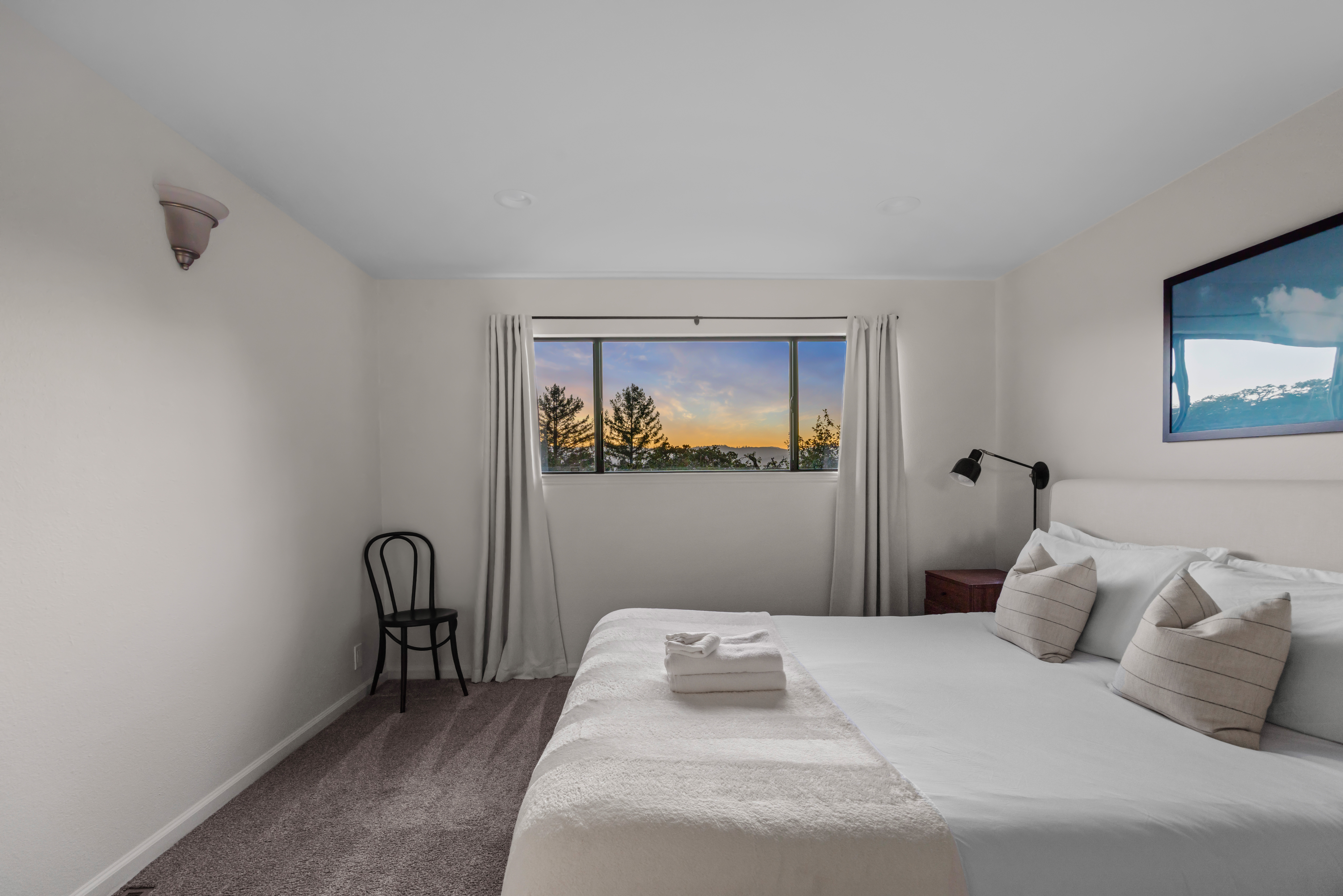 Serene bedroom with sunset views and crisp, hotel-style bedding
