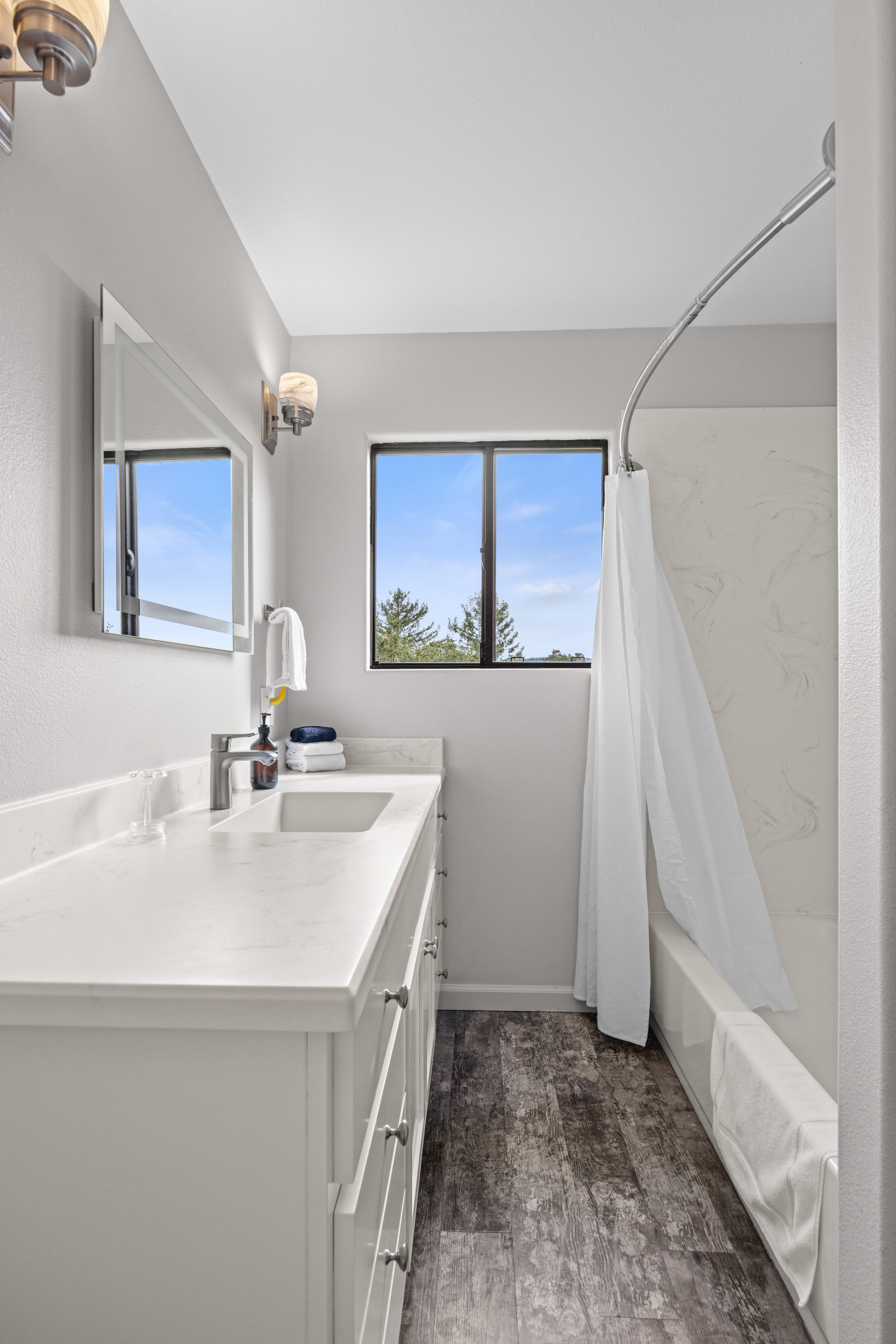 Bright modern bathroom with natural light and tub-shower combo