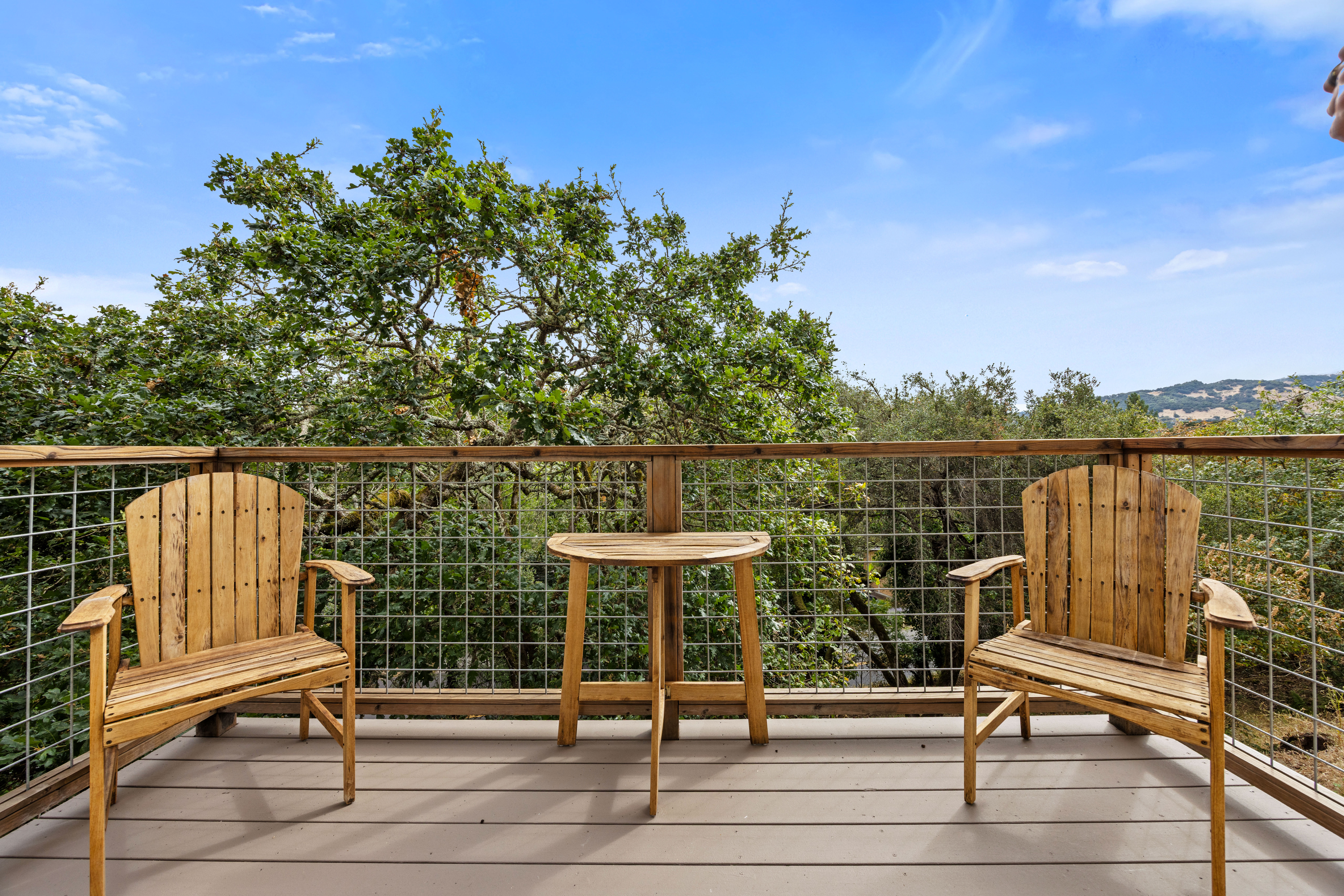 Private treetop deck with cozy seating and serene hillside views