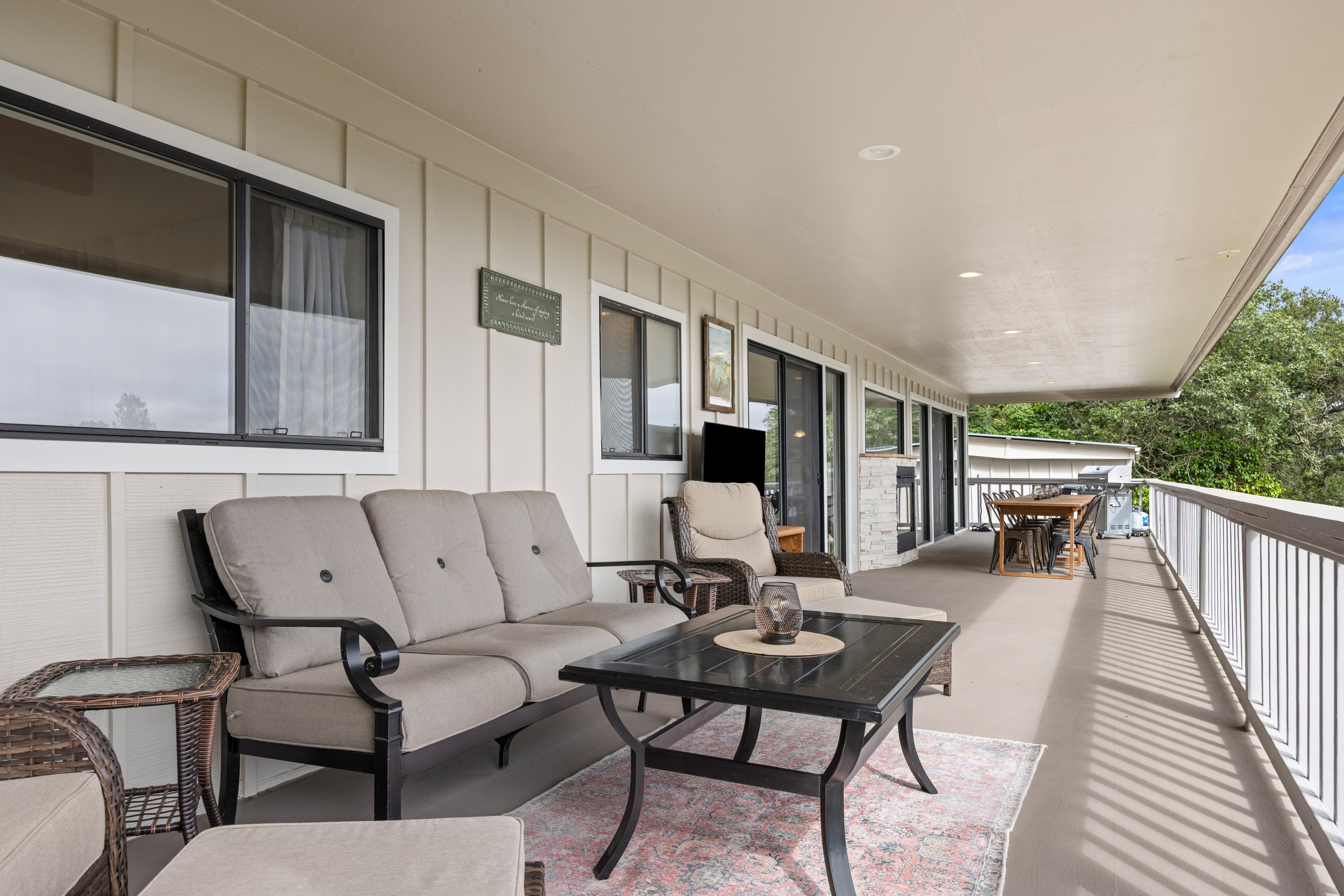 Spacious covered patio with lounge seating and outdoor dining area