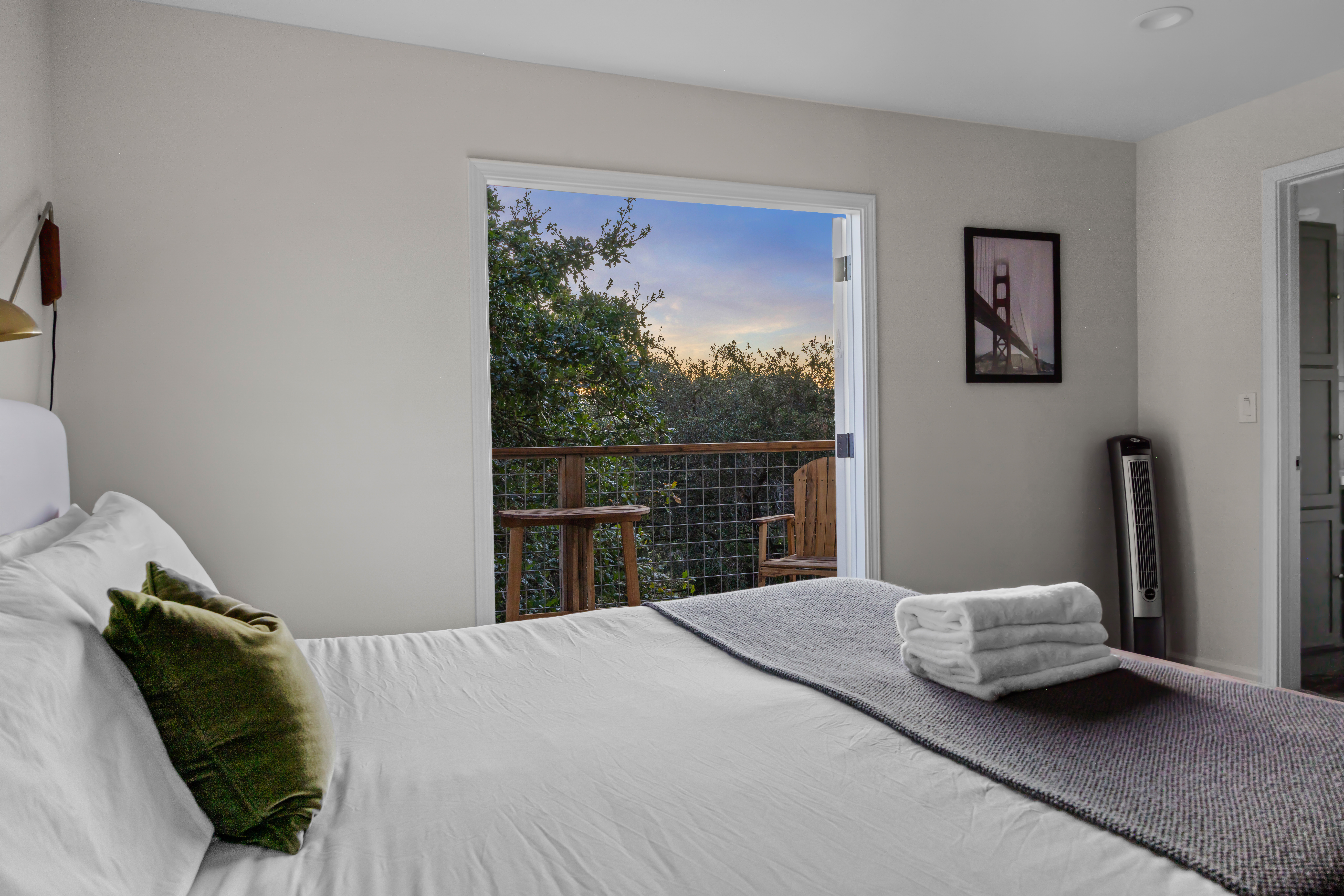 Cozy bedroom with private balcony and serene treetop views