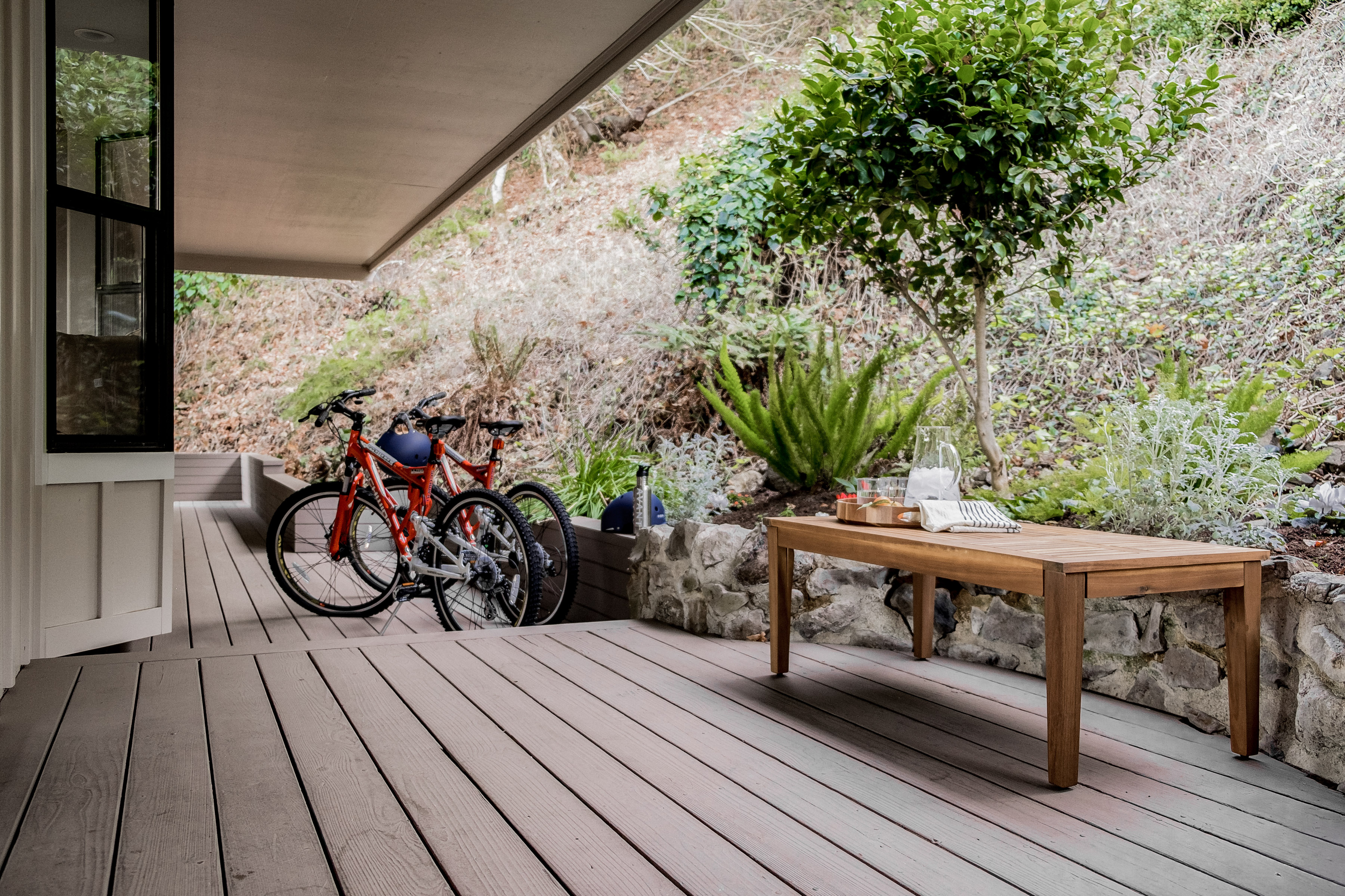 Covered garden deck with bikes, greenery, and a peaceful outdoor retreat