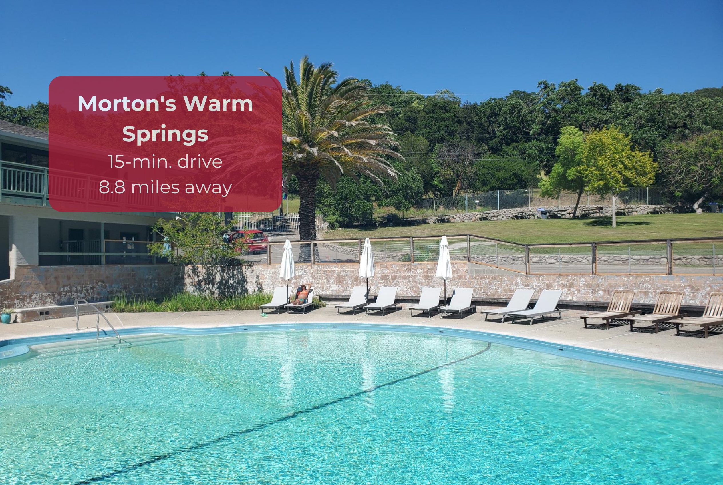 Resort-style pool with sunny loungers, lush views, and warm springs nearby