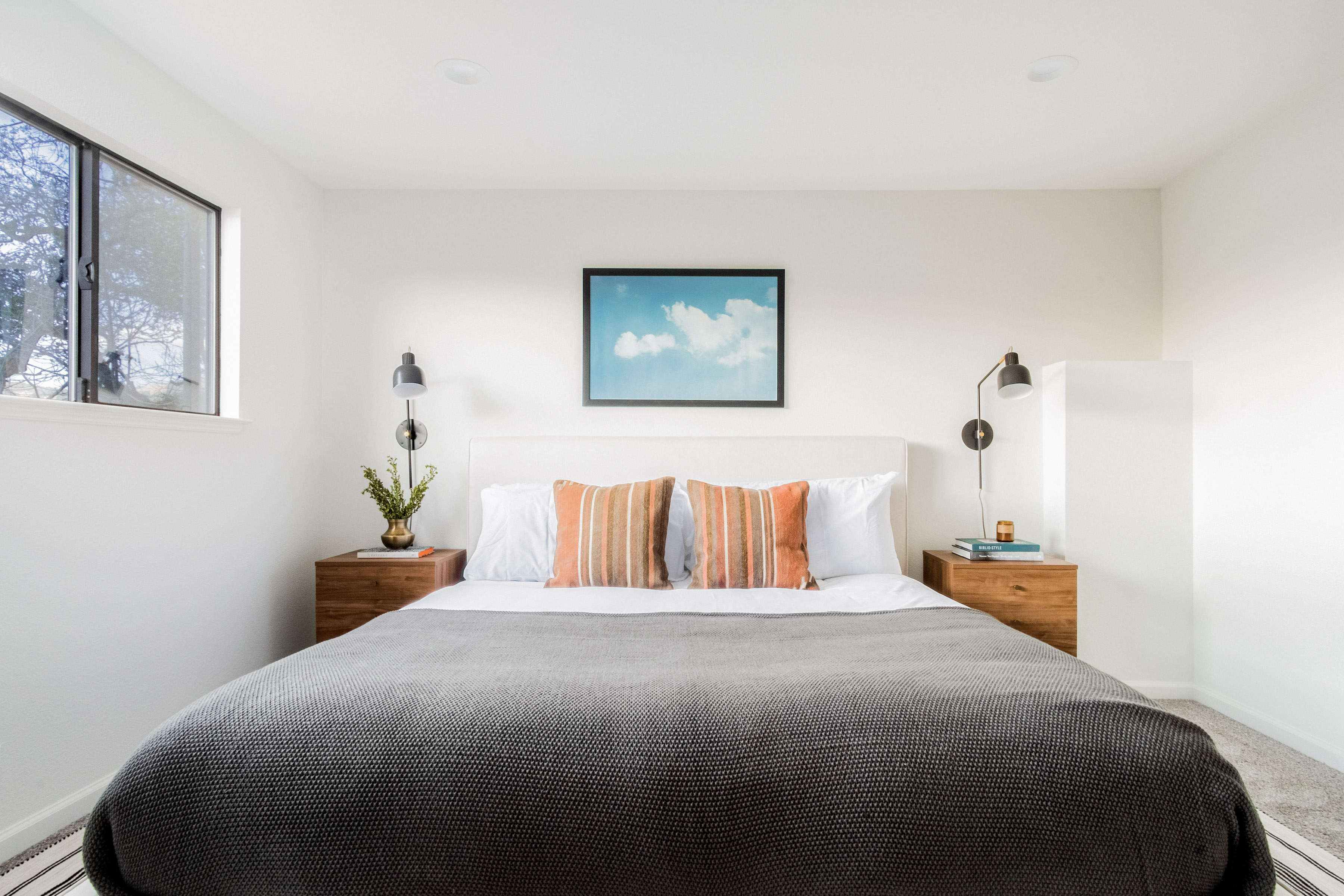 Bright, modern bedroom with a plush king bed and airy minimalist design