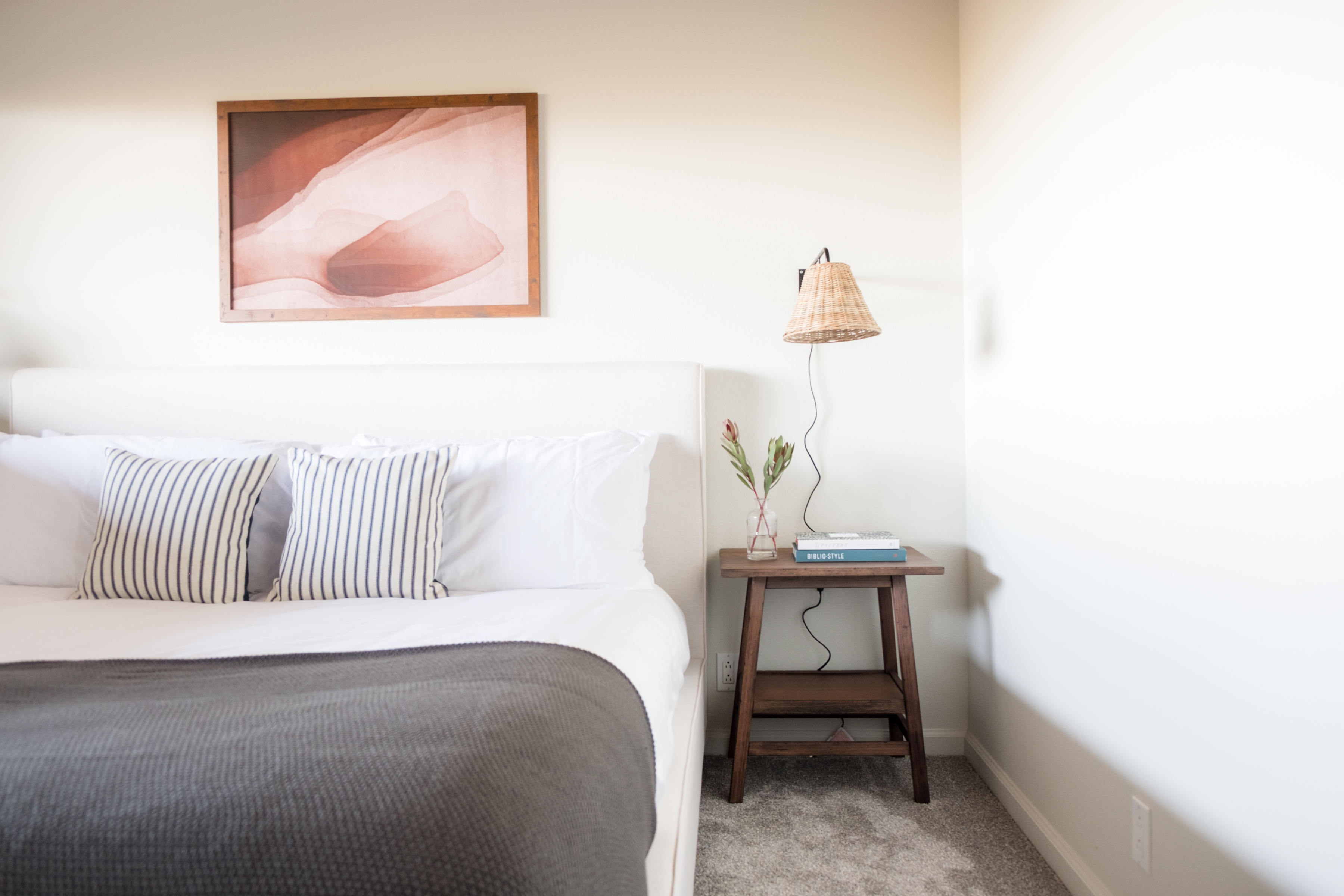 Bright, cozy bedroom with plush linens and warm modern styling