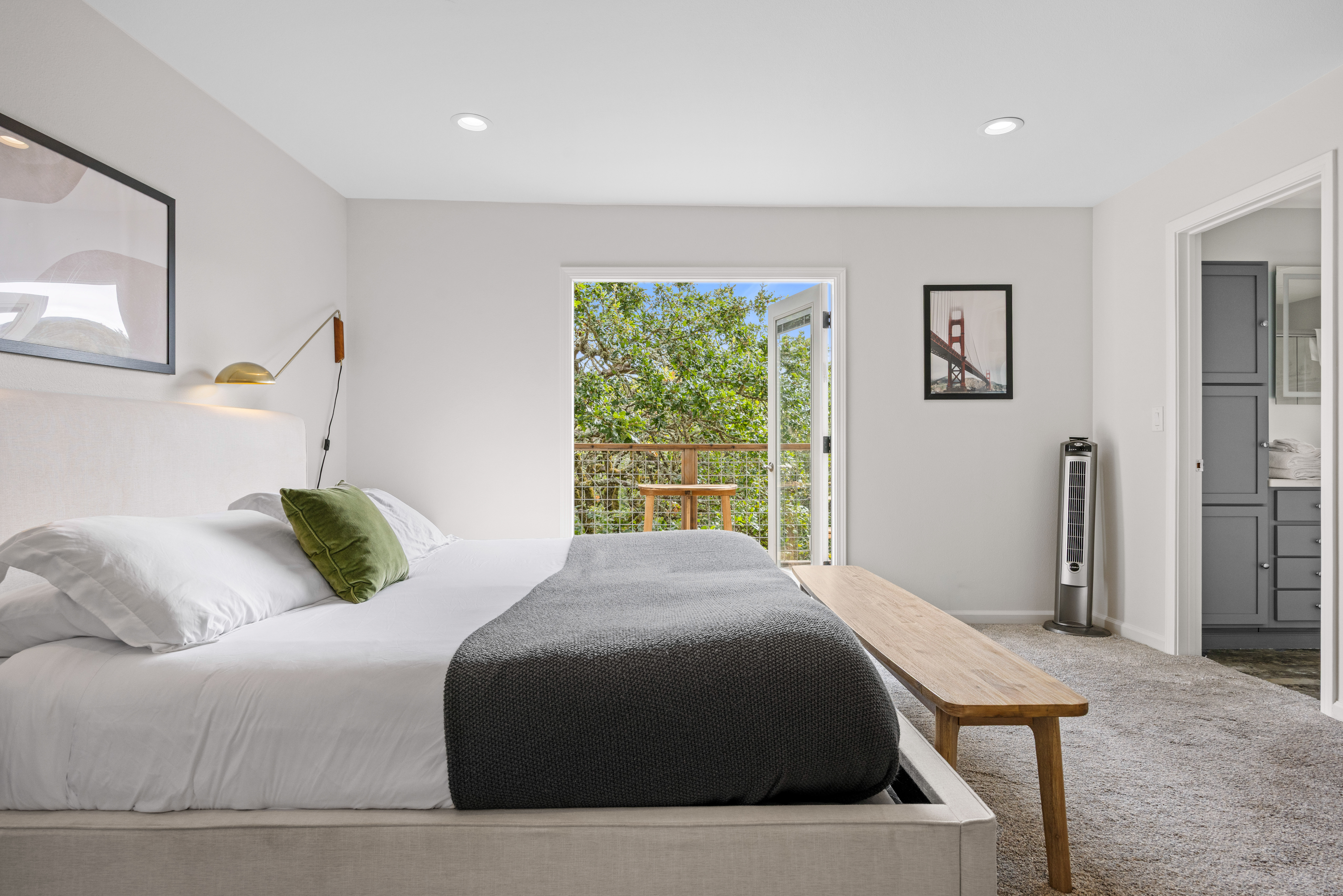 Bright bedroom with private balcony views and en suite bath