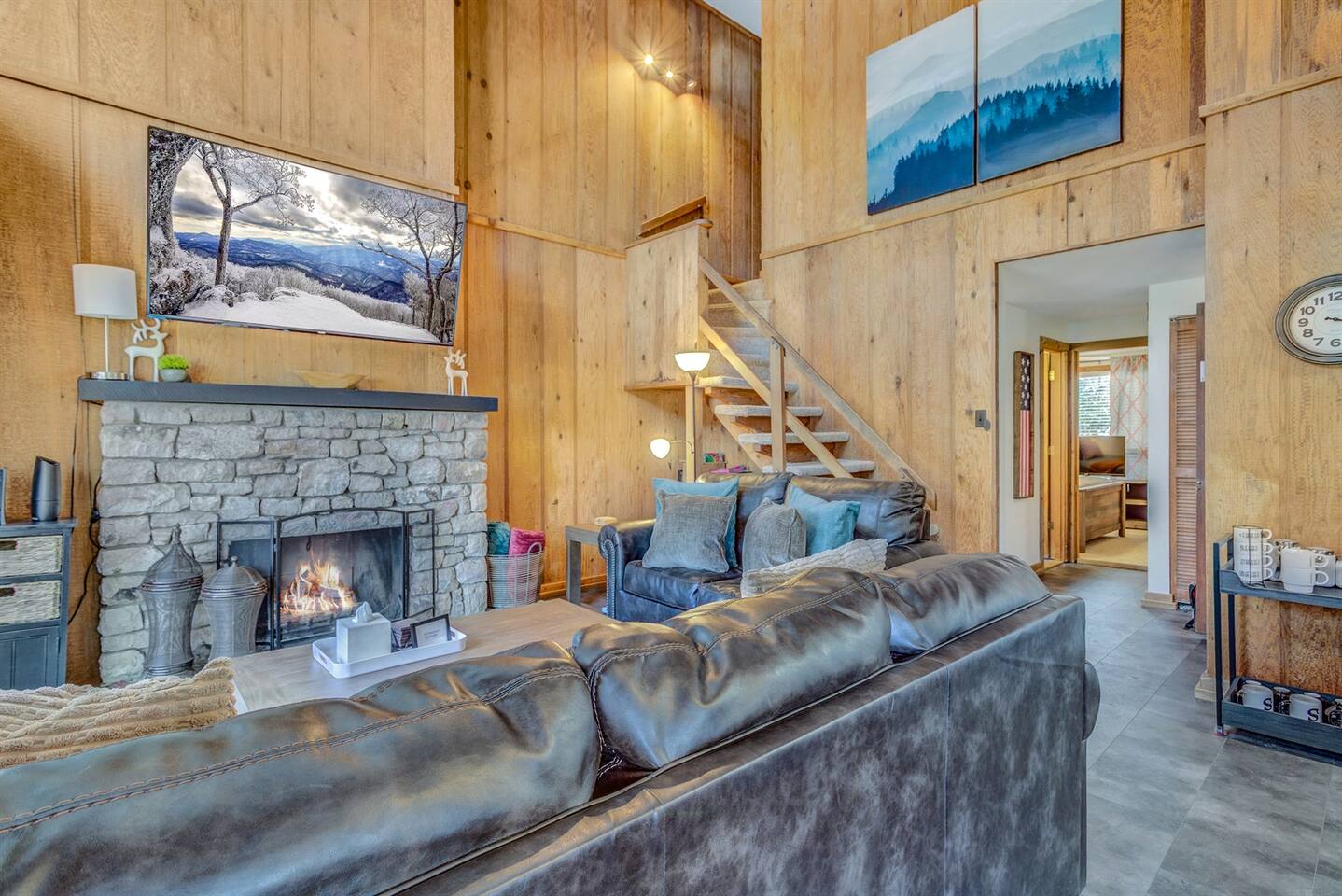 Spacious open-concept living room with stone gas fireplace