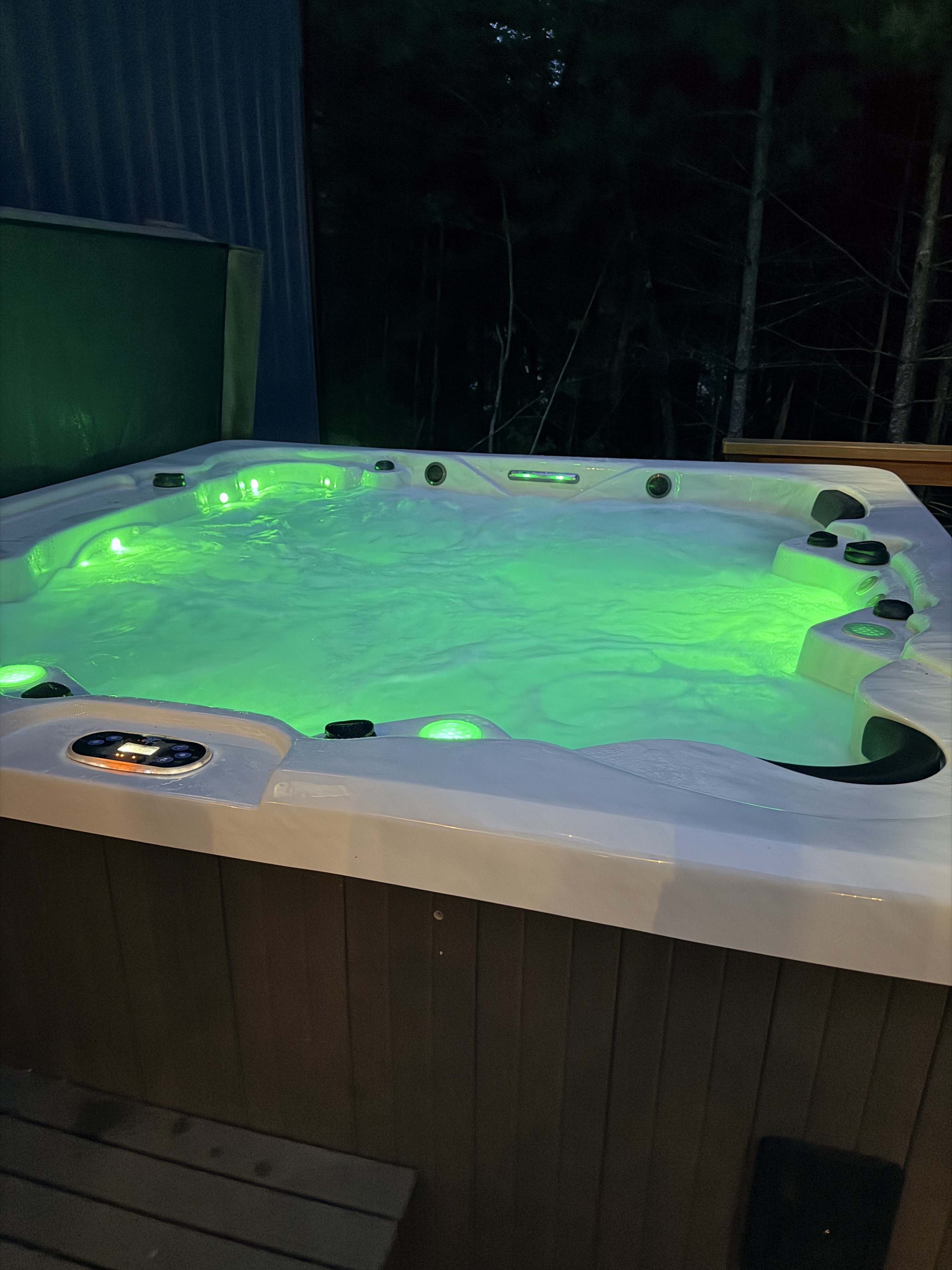 Private outdoor hot tub with glowing lights