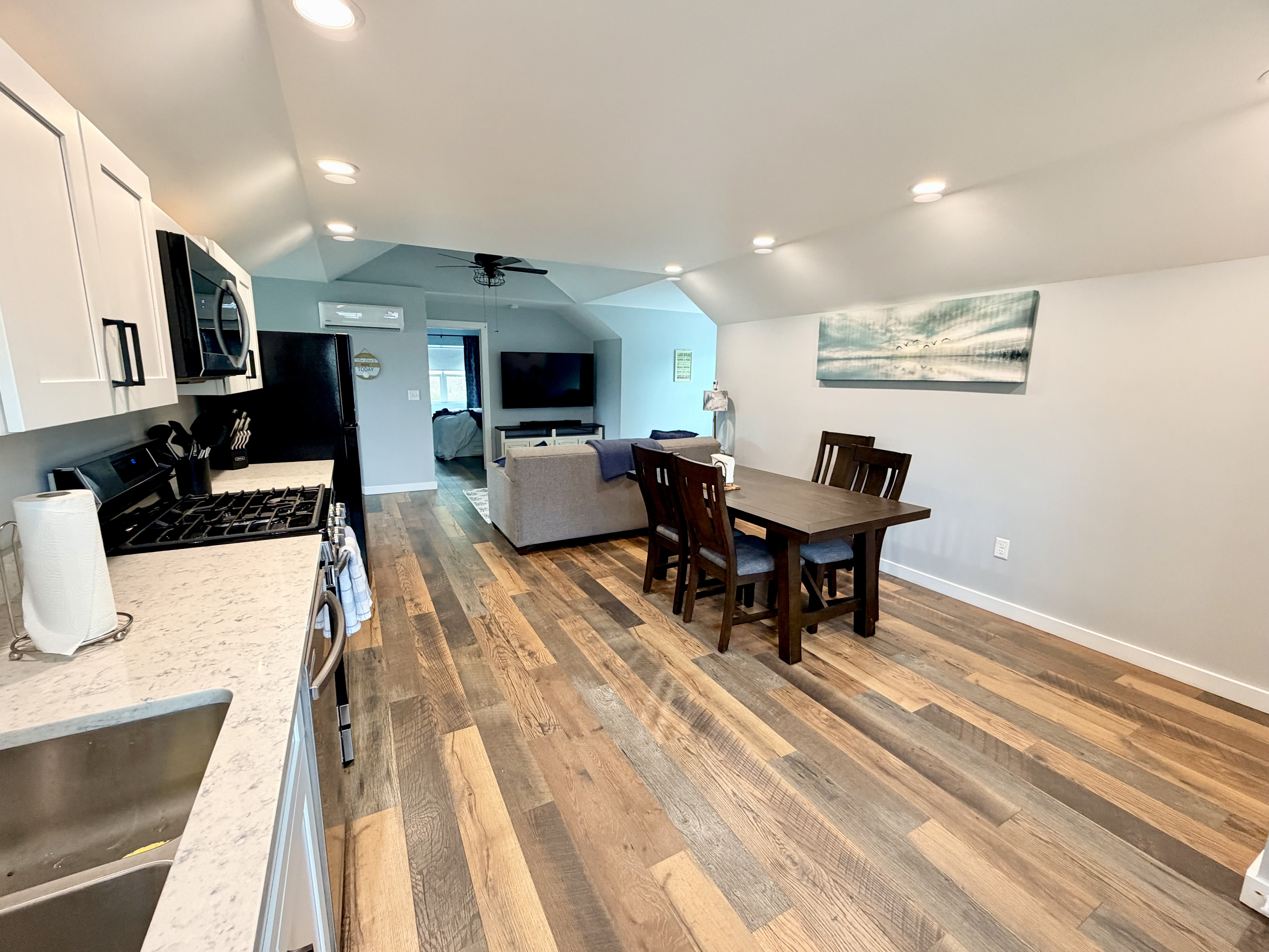 Open-concept kitchen, dining and living