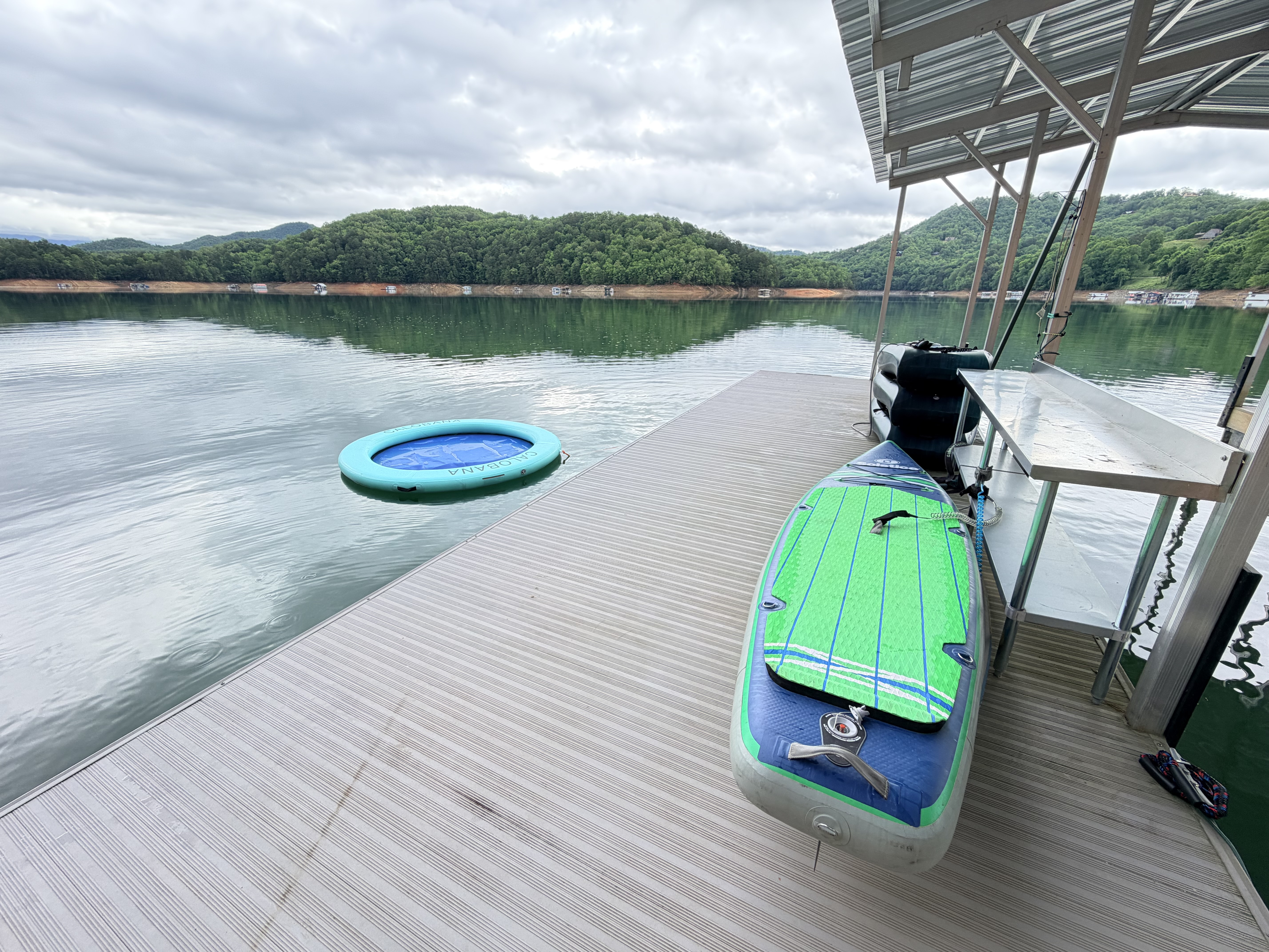 Covered lakefront dock with paddleboard