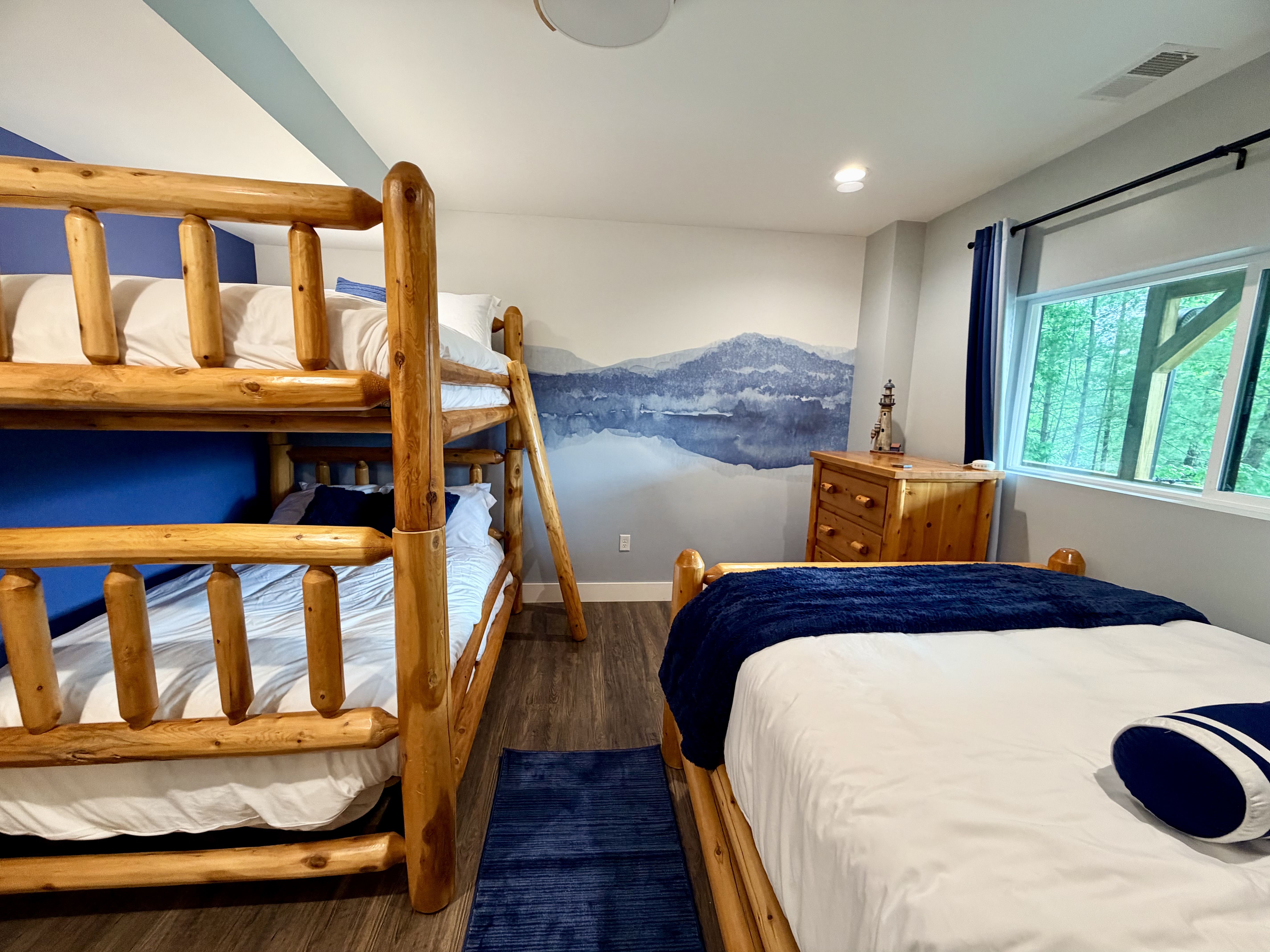 Rustic bunk room with mountain mural